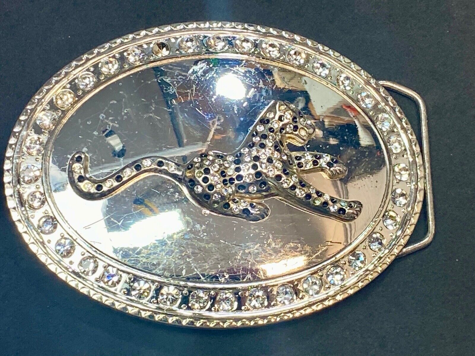 A big Tiger Cat running featured on western oval belt buckle 