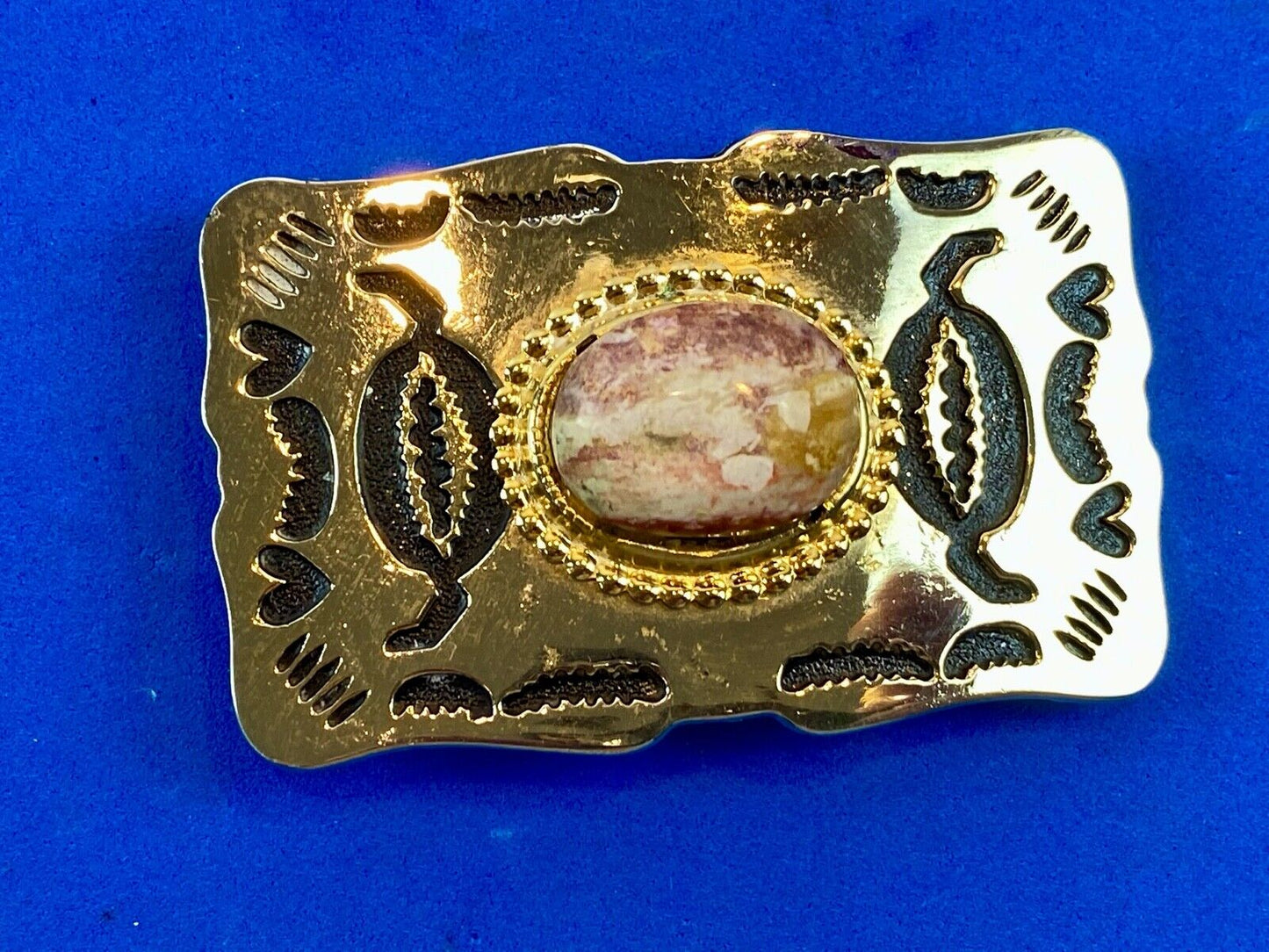 unknown multi layered colored stone as centerpiece in western belt buckle