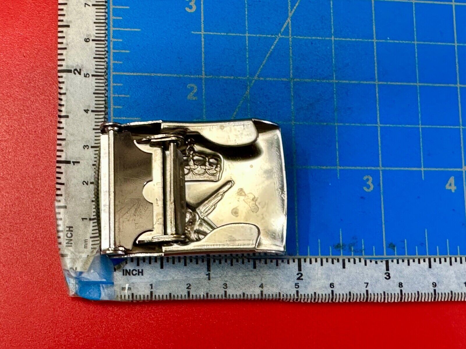 unknown to me!   dress style silver tone crown X crest? stamped belt buckle