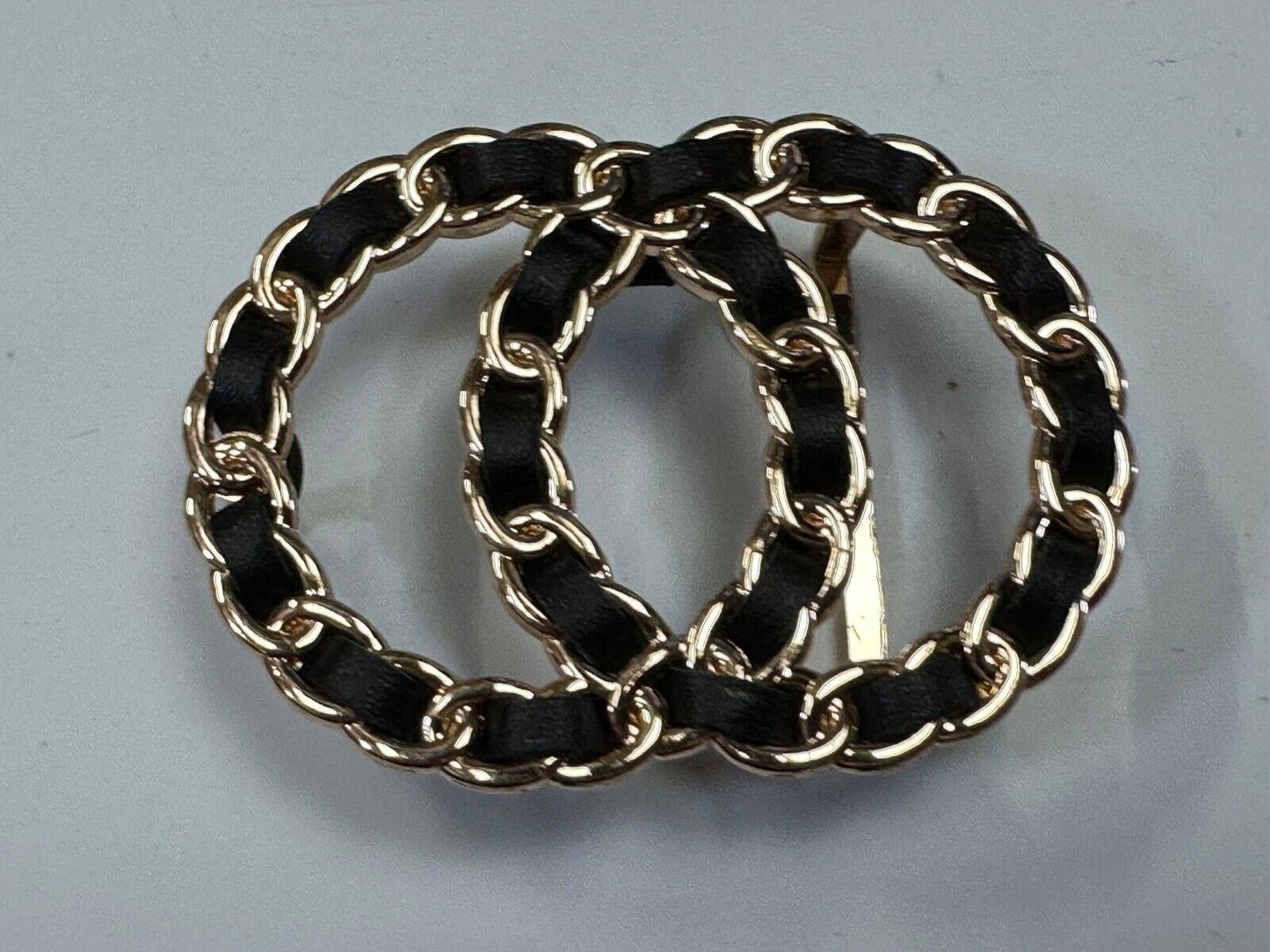Two gold tone Overlapping Circle's with black ribbon through-out belt buckle