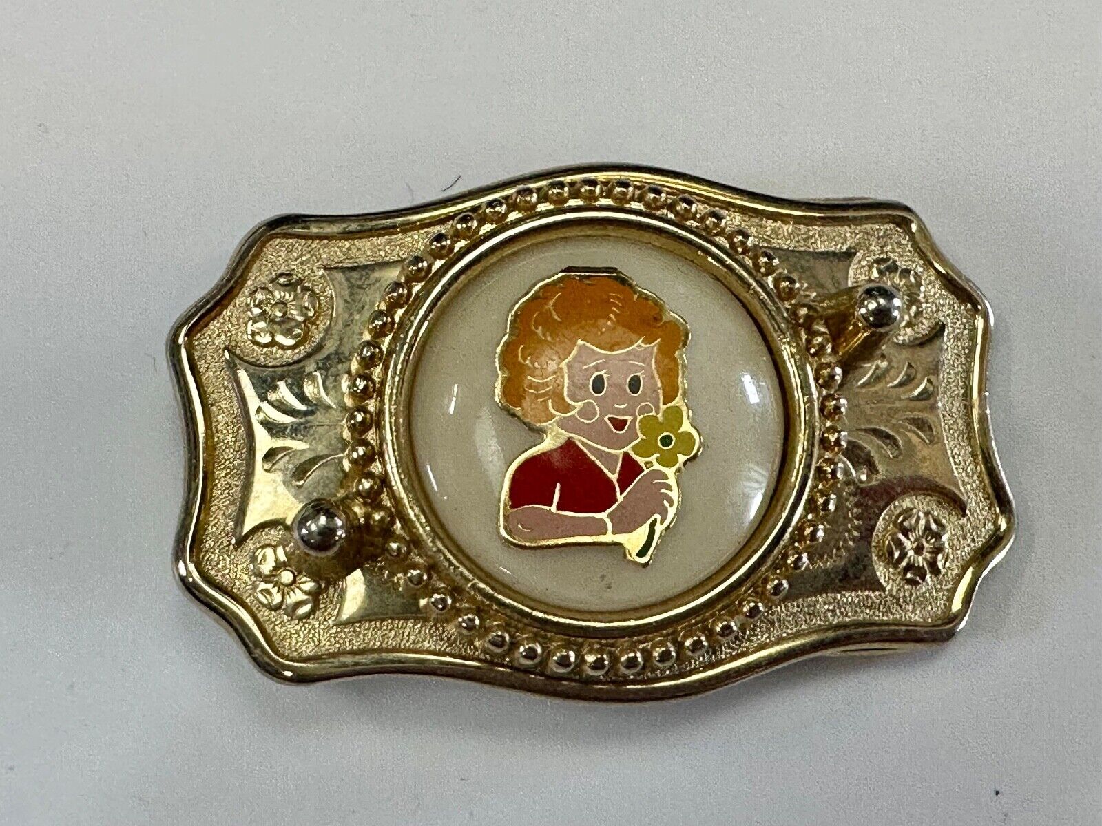 Adorable red headed girl with flower as centerpiece on western belt buckle