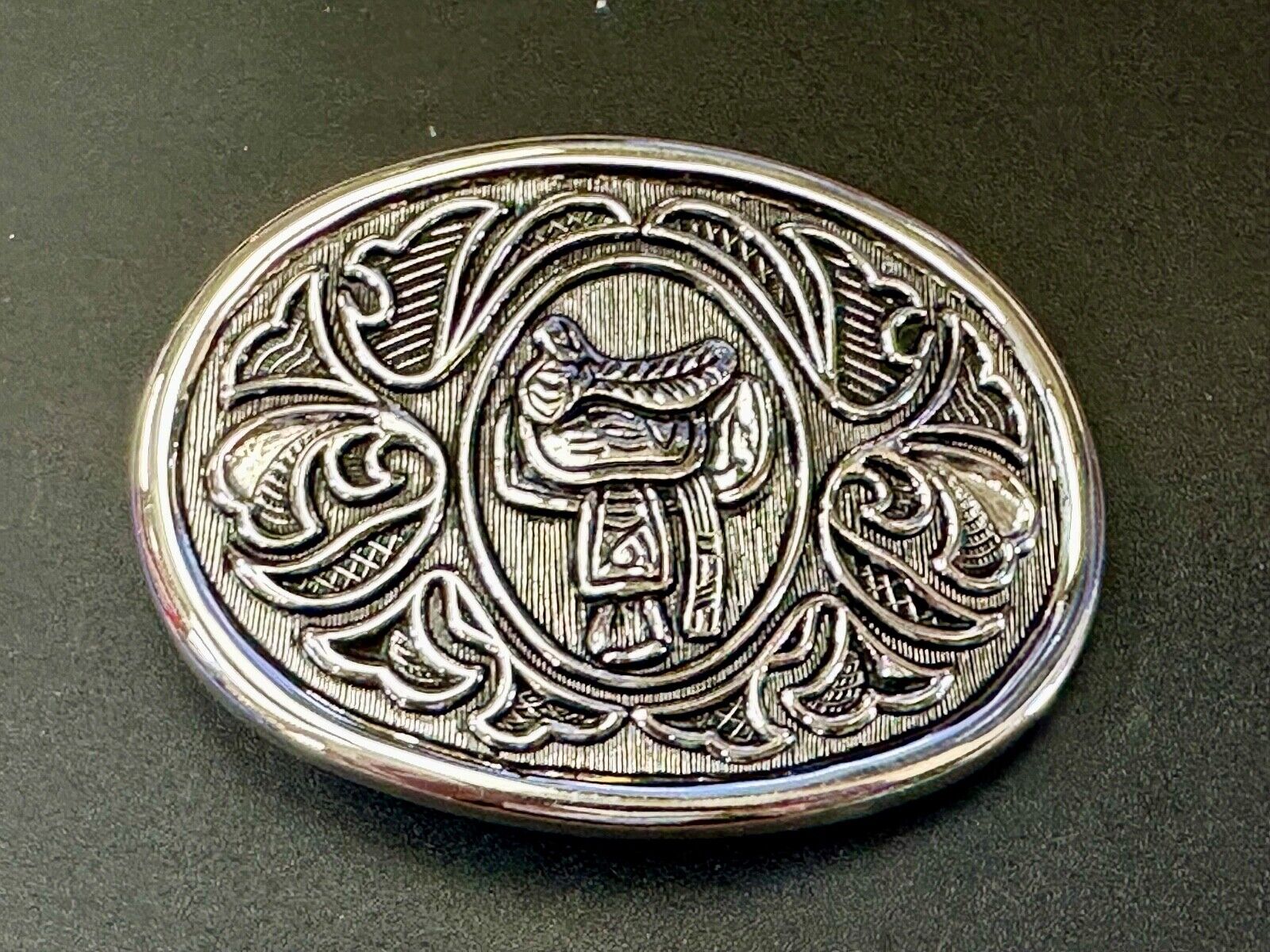 Vintage Cowboy's Horse Saddle ornate flower swirl oval belt buckle by Avon