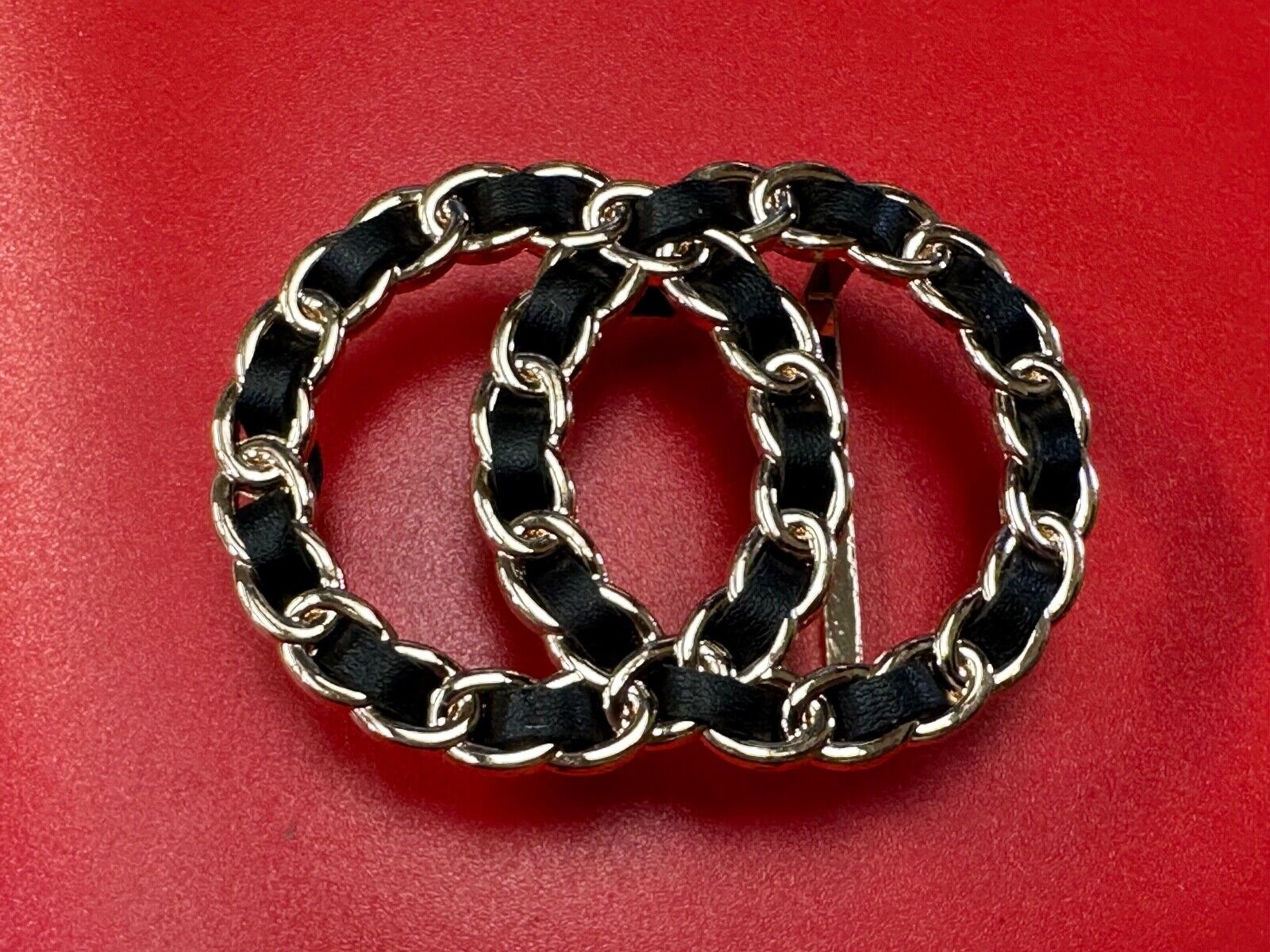 Two gold tone Overlapping Circle's with black ribbon through-out belt buckle