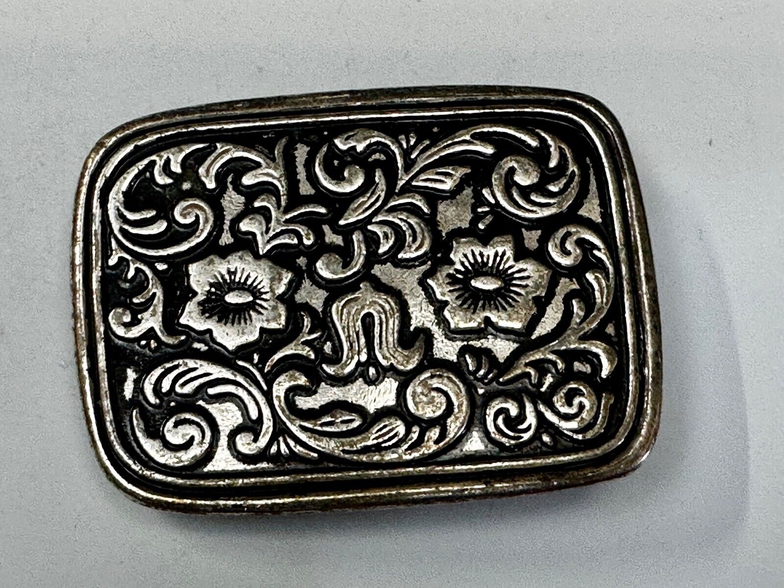Vintage black and silver tone western flower floral theme cowboys belt buckle