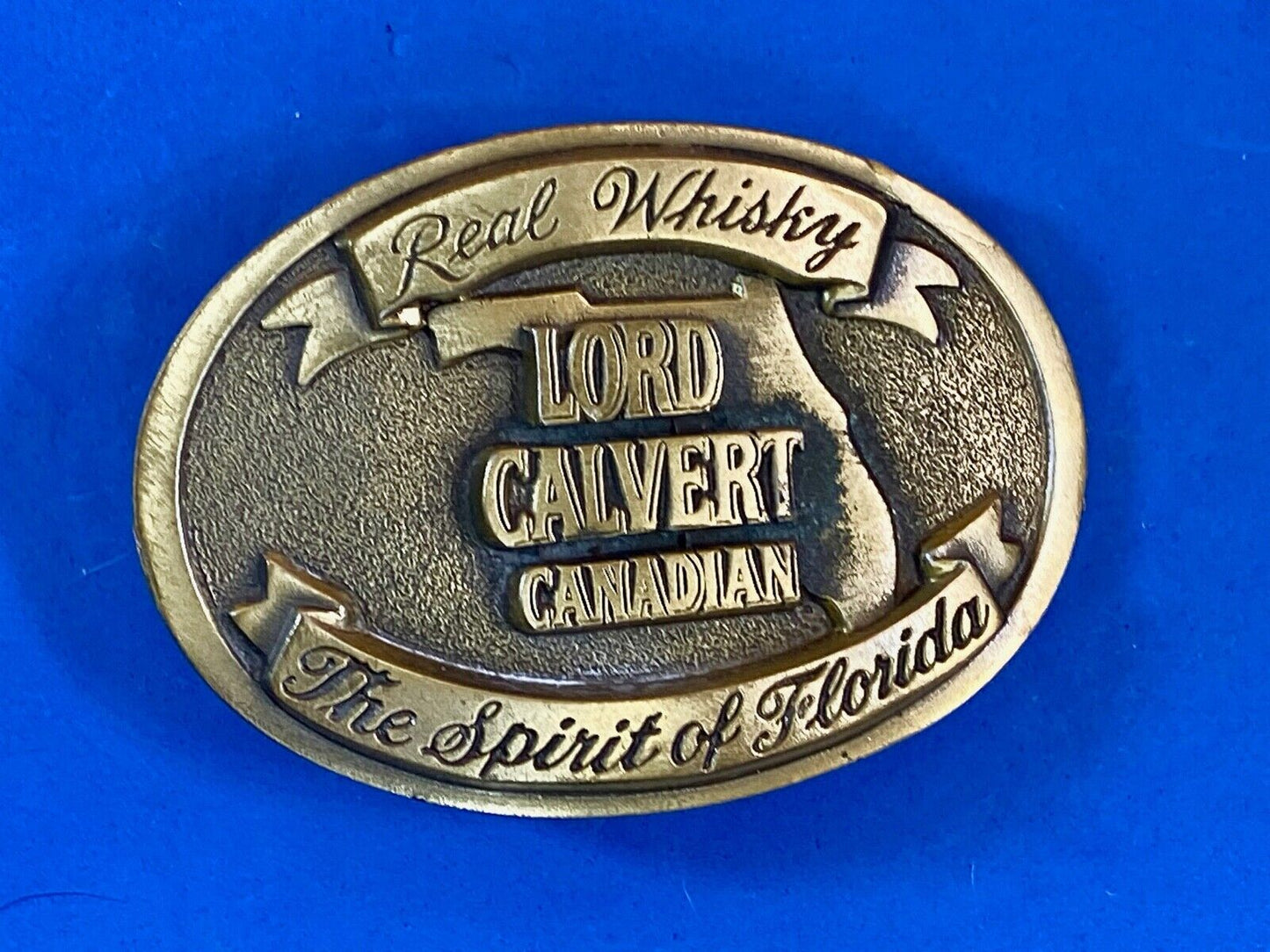 Vintage Lord Calvert Canadian Real Whisky.  Spirit Of Florida Belt Buckle 