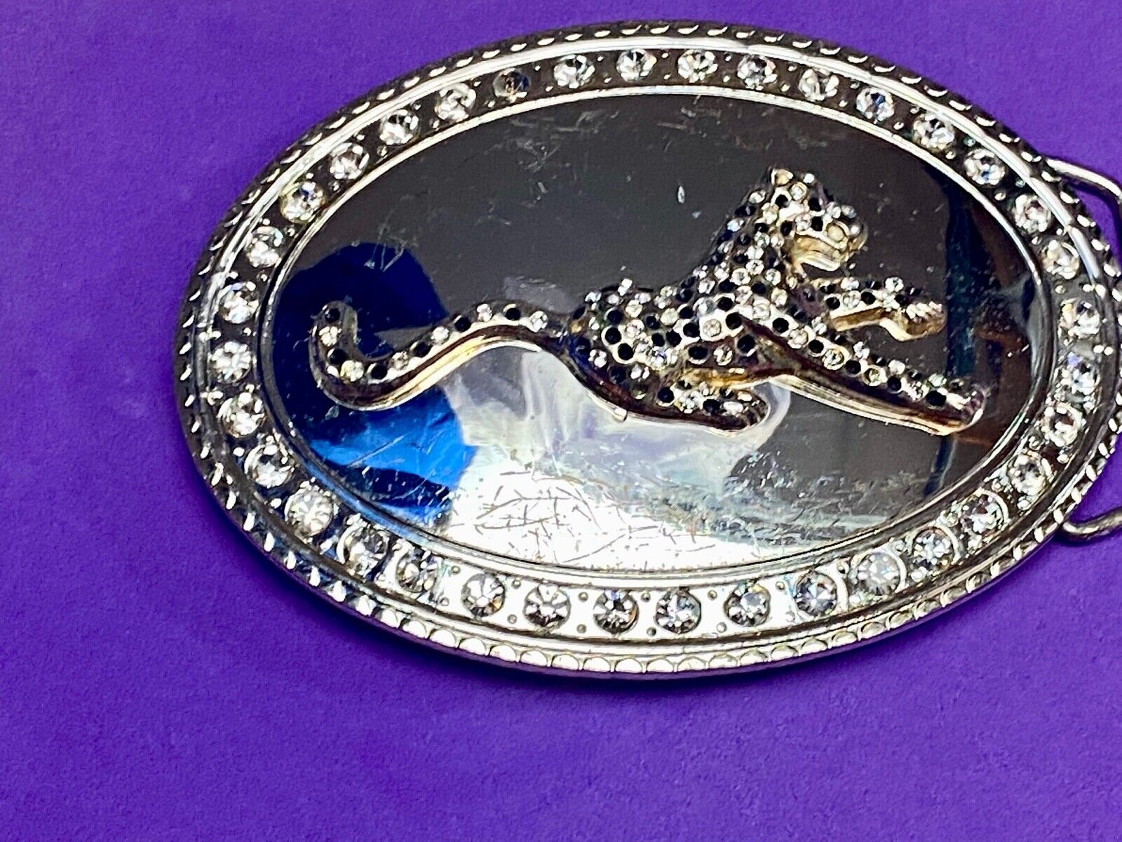 A big Tiger Cat running featured on western oval belt buckle 