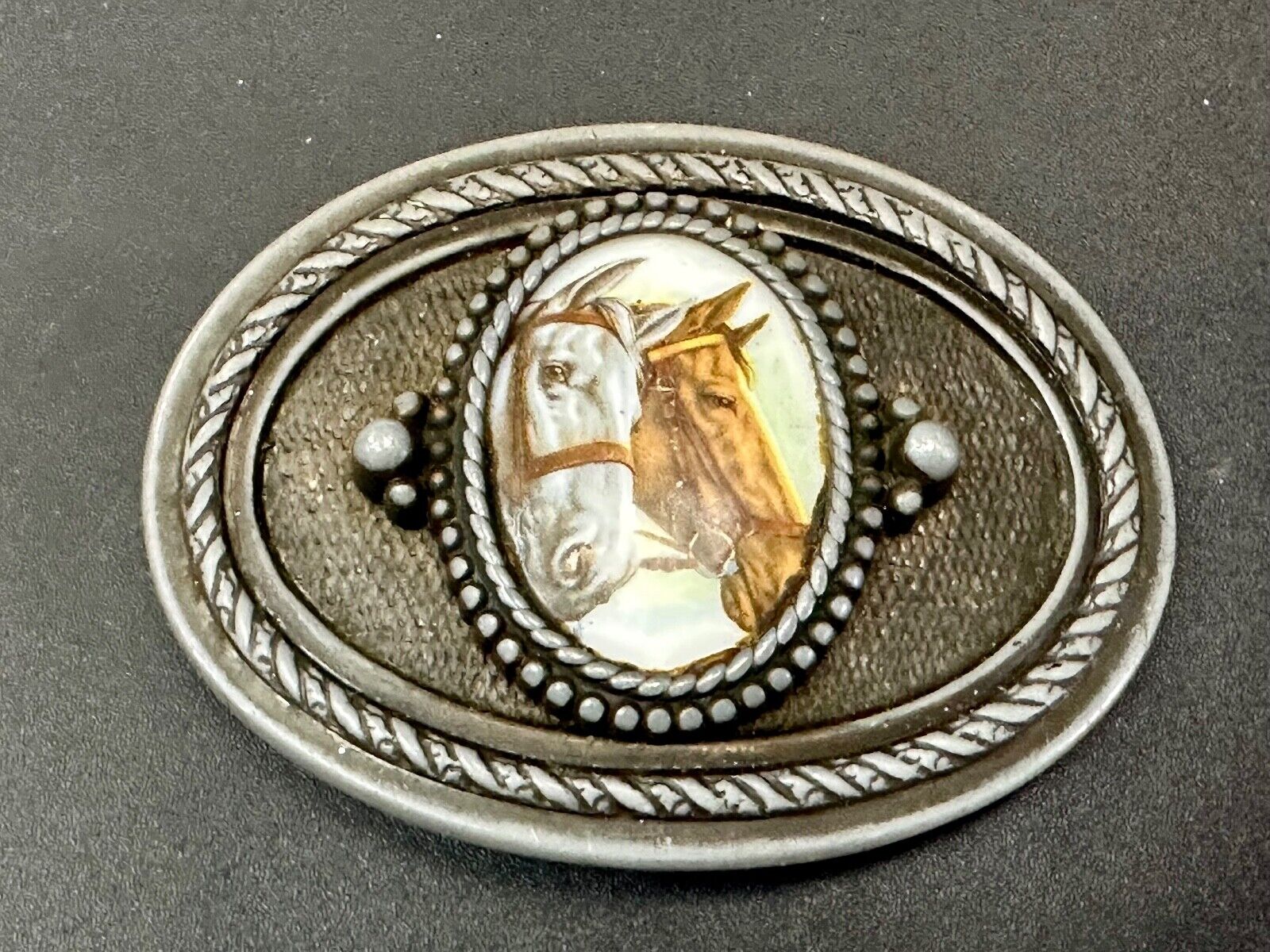 2 horses picture as centerpiece in western oval belt buckle with rope border