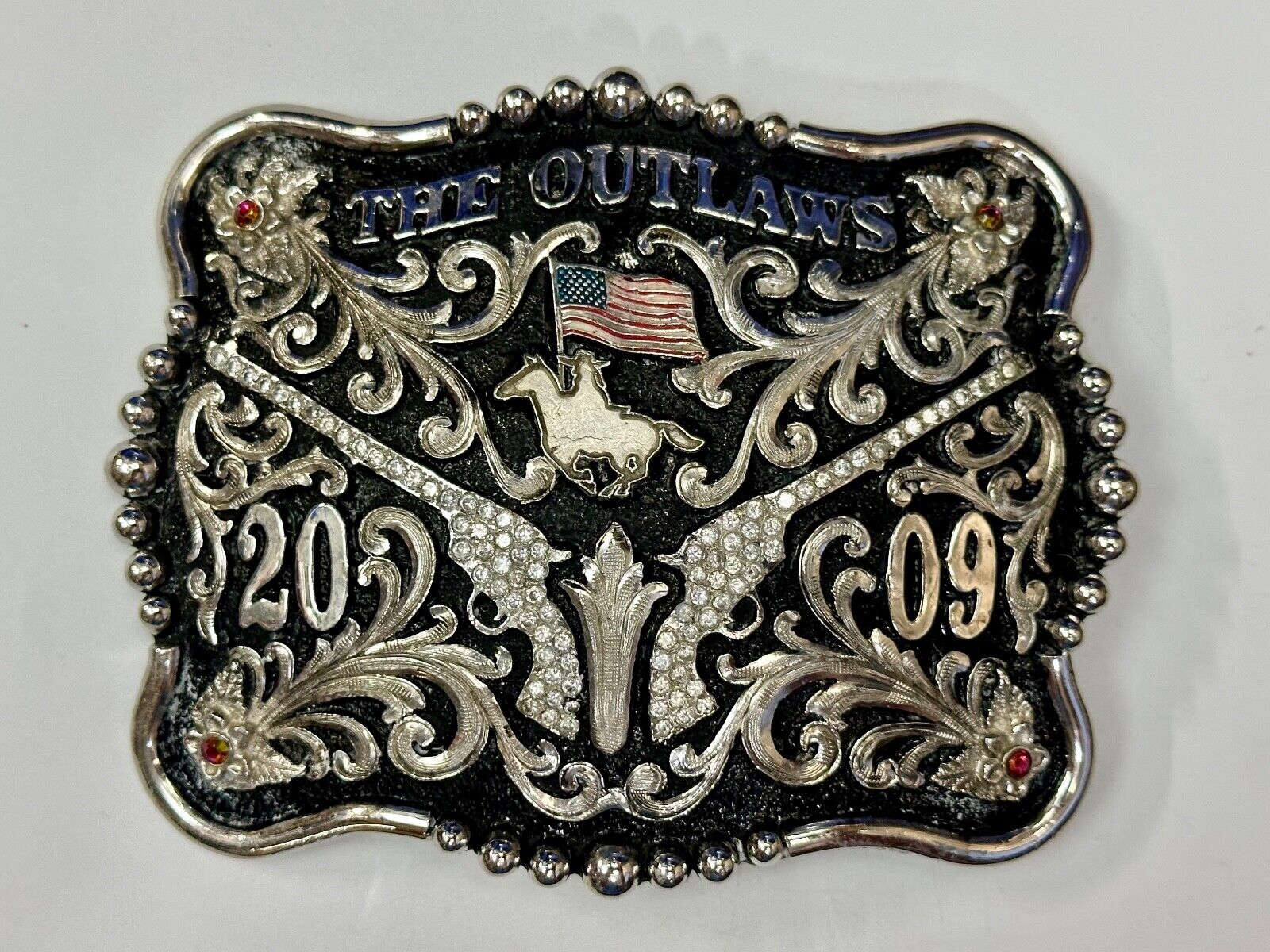 The Outlaws Rodeo Cowboy Trophy 2009 Flag Belt Buckle - Crossroads bucklesTexas