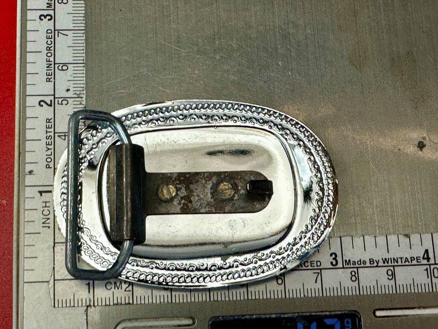 70s Covered Wagon two tone reflective oval ornate boarder belt buckle
