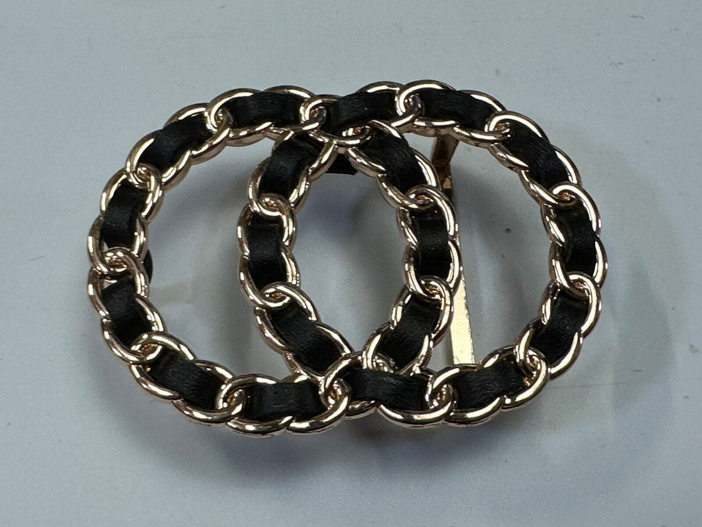 Two gold tone Overlapping Circle's with black ribbon through-out belt buckle
