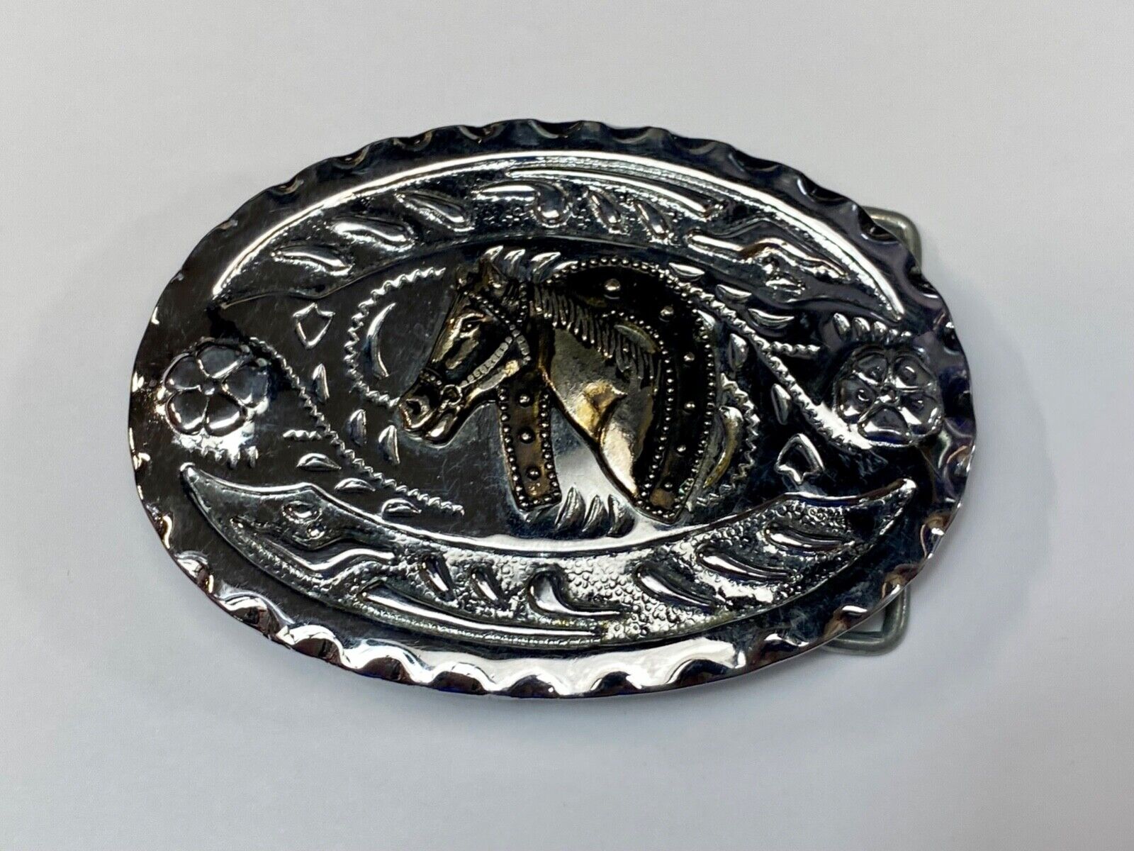 Vintage horse head through lucky horseshoe on mixed metal western belt buckle