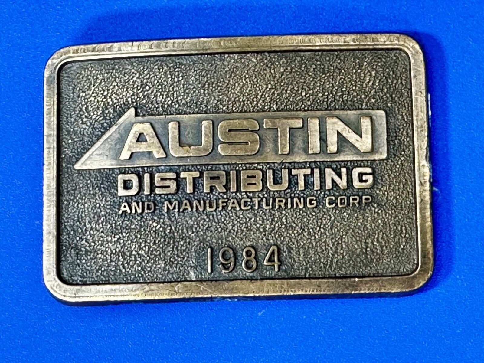 Austin Texas Distributing and Manufacturing 1984 Advertisement Promo Belt Buckle