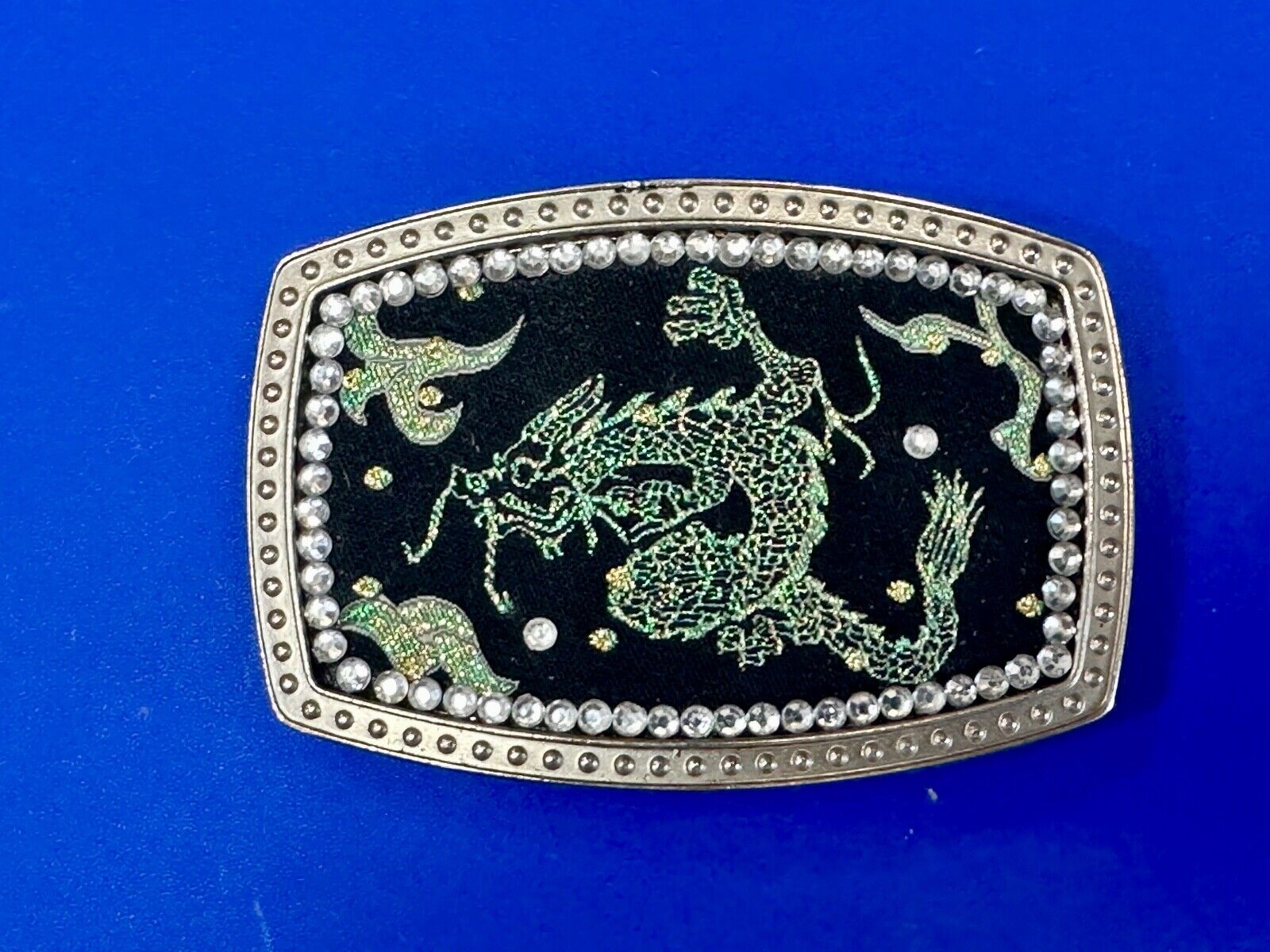 Chinese Dragon pattern symbol on silver tone rhinestone accented belt buckle