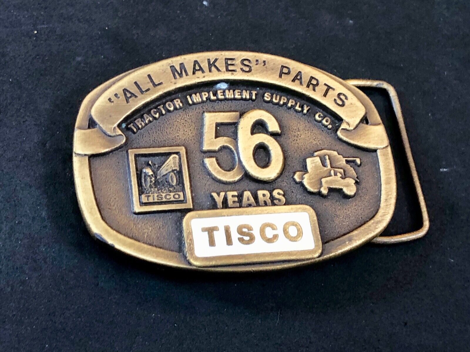 TISCO -   56 years tractor farming parts supply store advertising belt buckle 