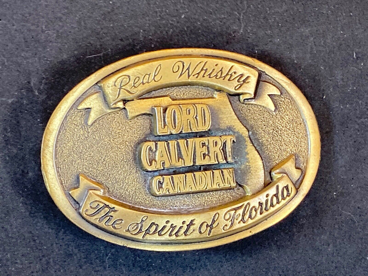 Vintage Lord Calvert Canadian Real Whisky.  Spirit Of Florida Belt Buckle 