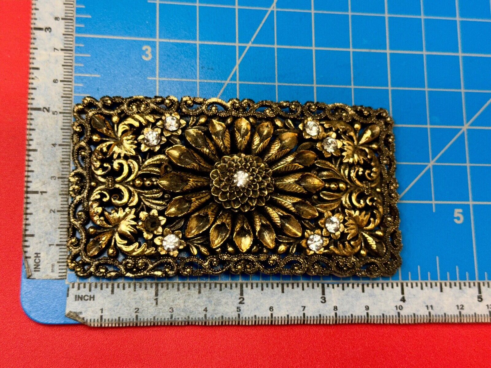 Antique gold tone? Flower theme Rhinestone covered scarf slide belt loupe buckle