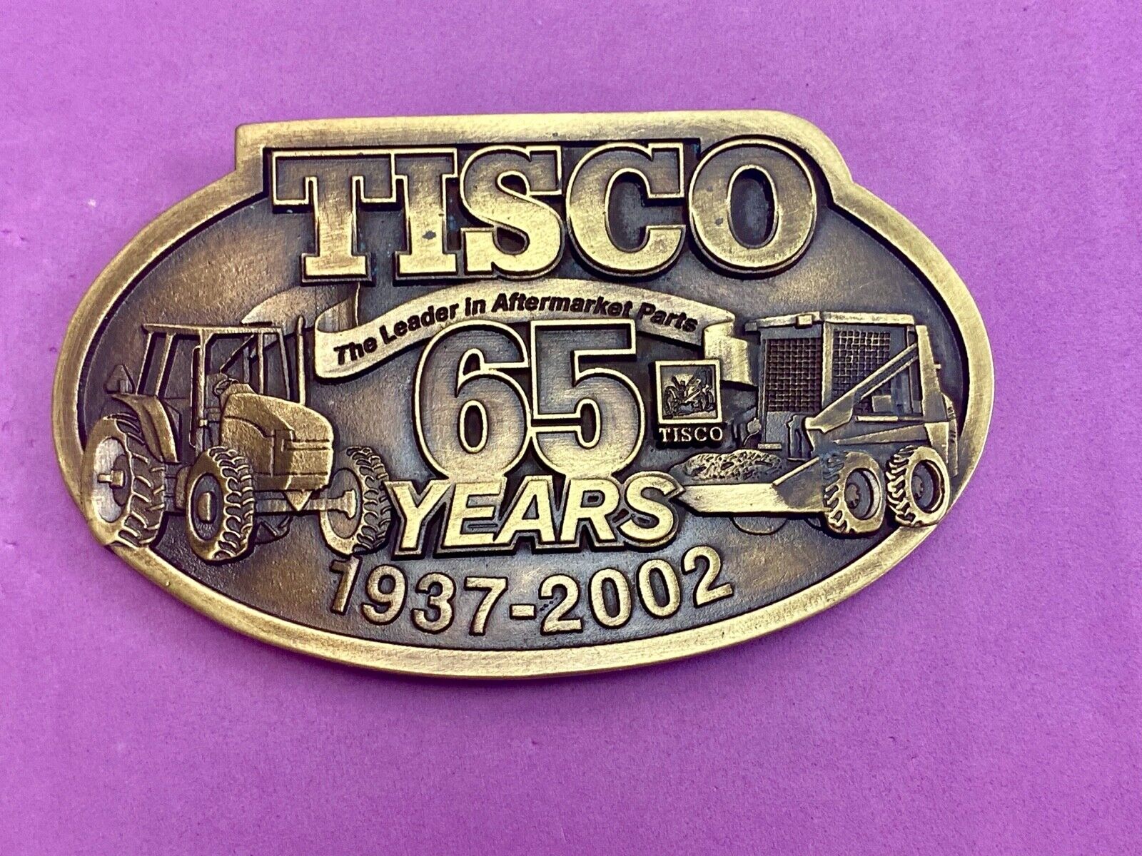 65 years - Tisco Tractor Implement Supply Spec Cast Farming Belt Buckle 
