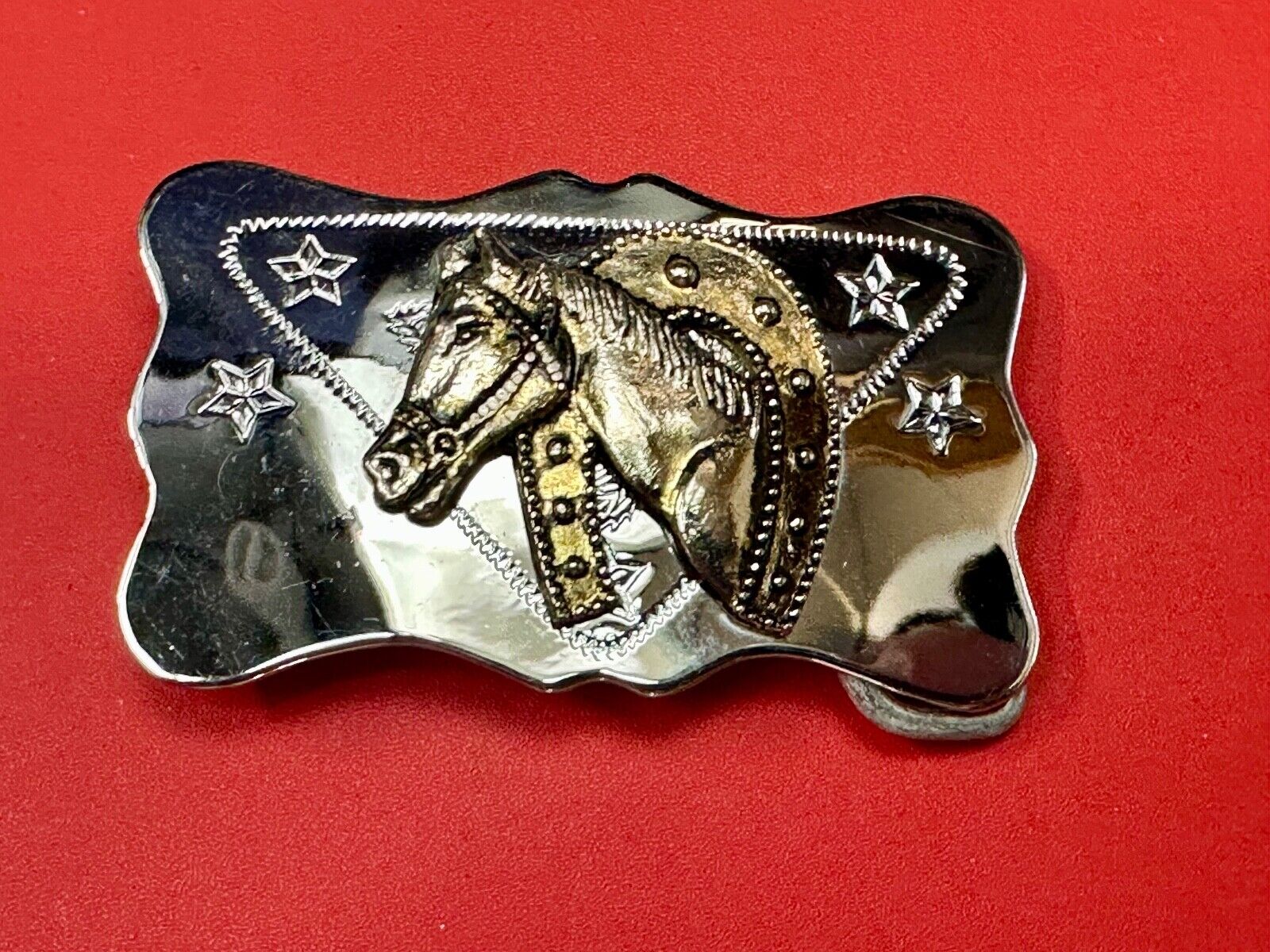 Vintage horse head through lucky horseshoe on reflective western belt buckle