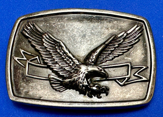 American Eagle with wings wide flying high in front of ribbon belt buckle