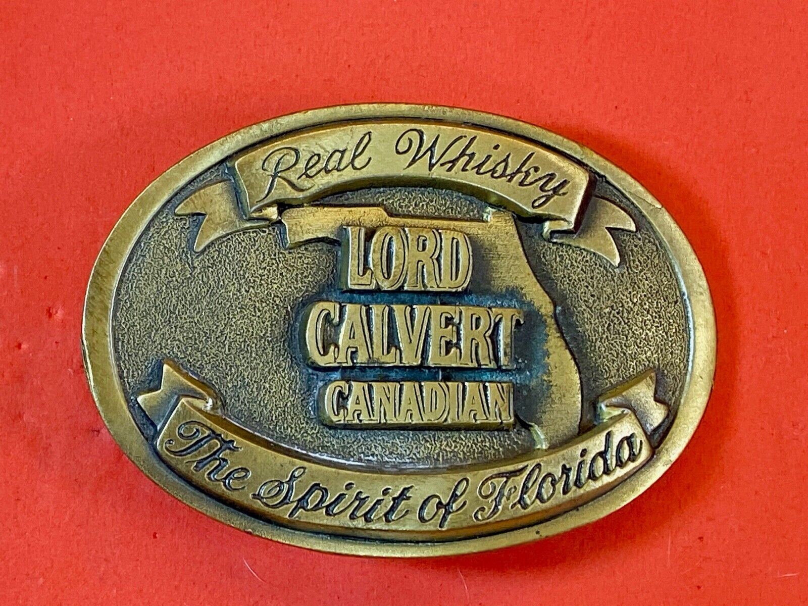 Vintage Lord Calvert Canadian Real Whisky.  Spirit Of Florida Belt Buckle 