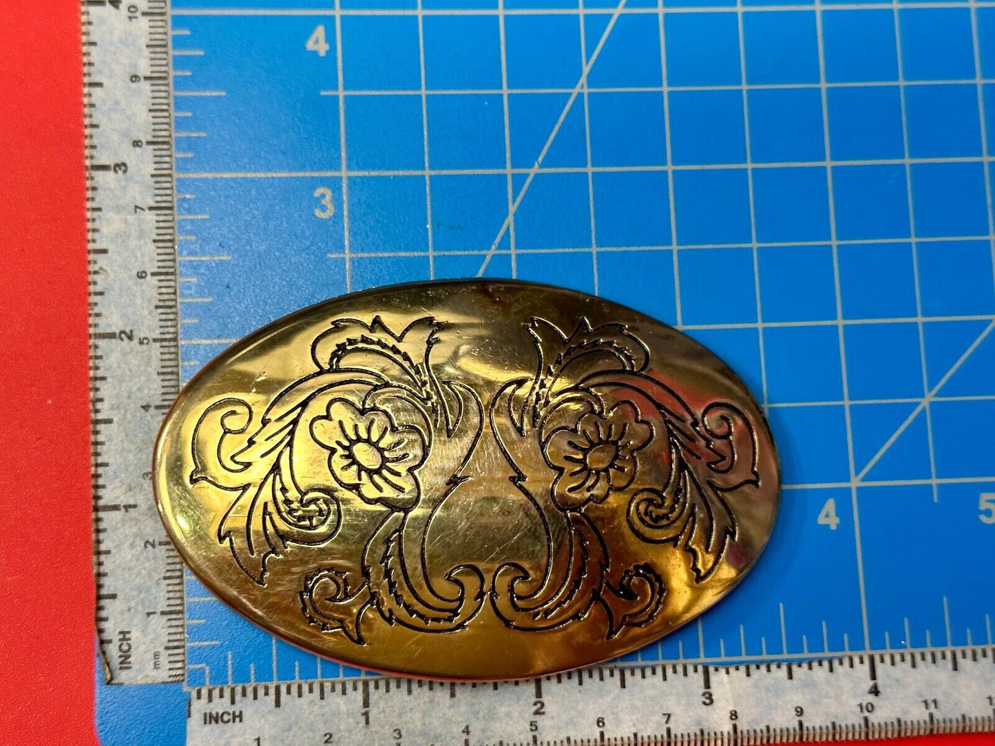 Antique? Engraved flower swirl pattern on gold color oval belt buckle