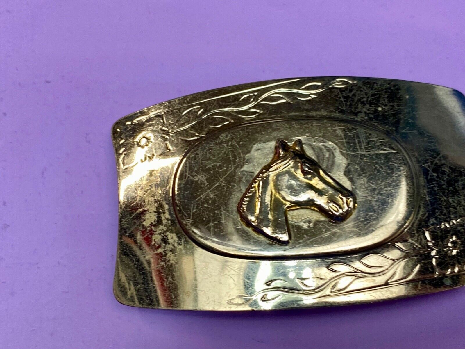 Vintage horse head on western belt buckle