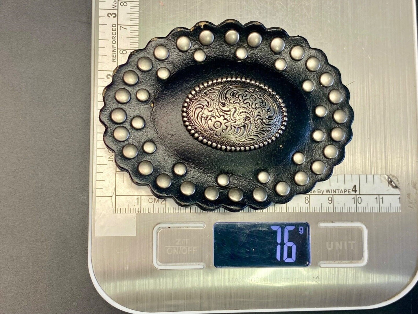 4" wide studded black leather oval belt buckle with flower swirl center
