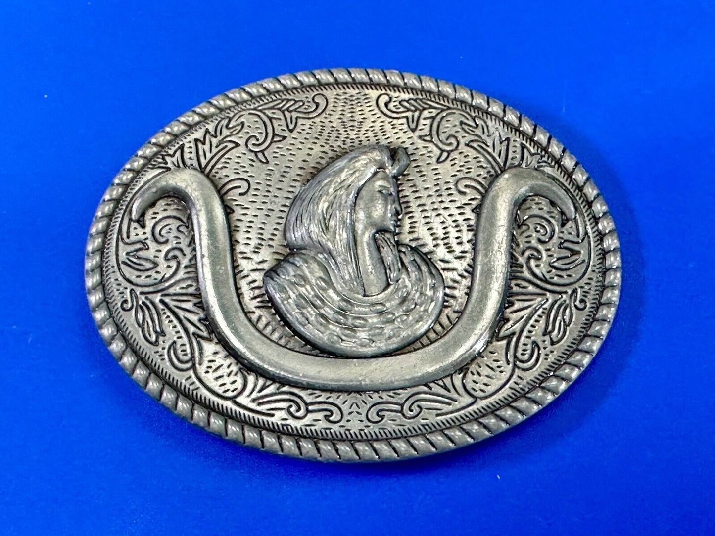 unknown to me!   Man with long hair - longhorn wester belt buckle
