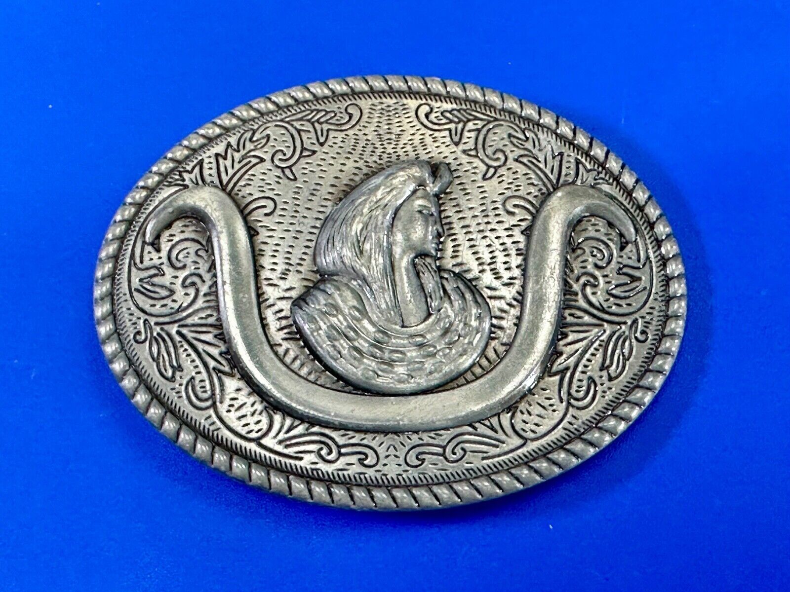 unknown to me!   Man with long hair - longhorn wester belt buckle