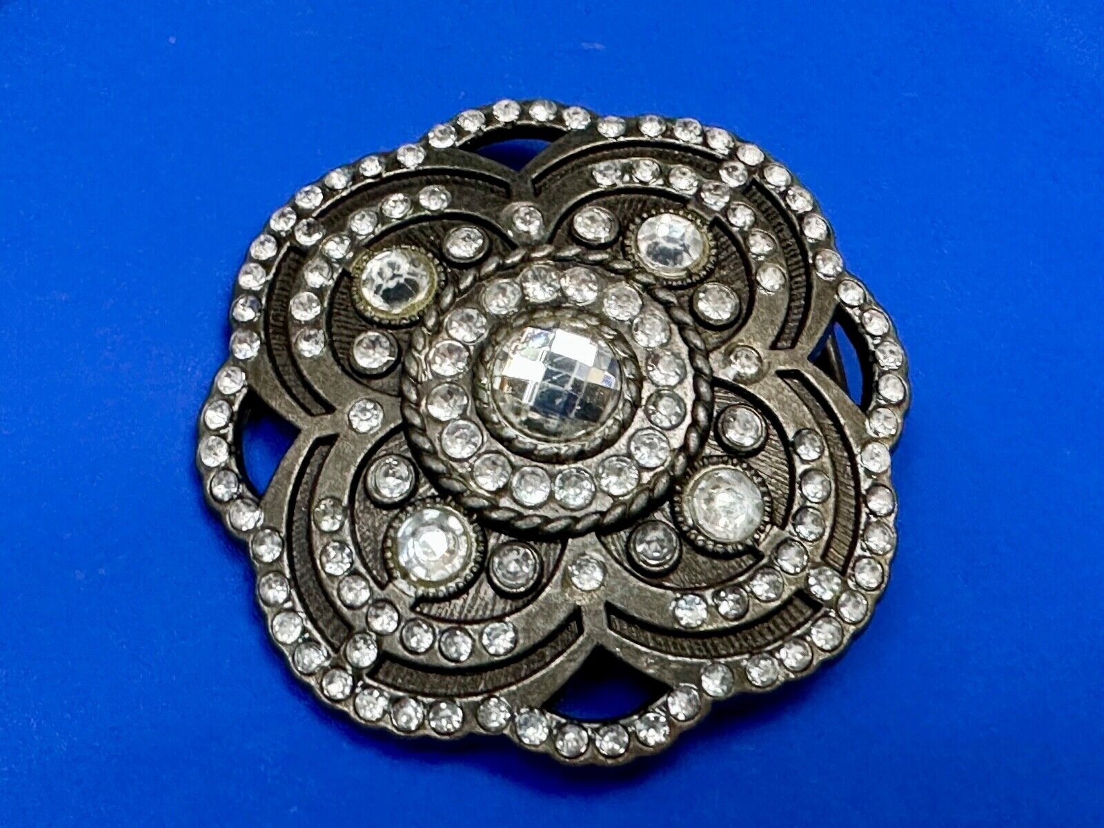 Beautiful Rhinestone accented see through flower shaped cutout belt buckle
