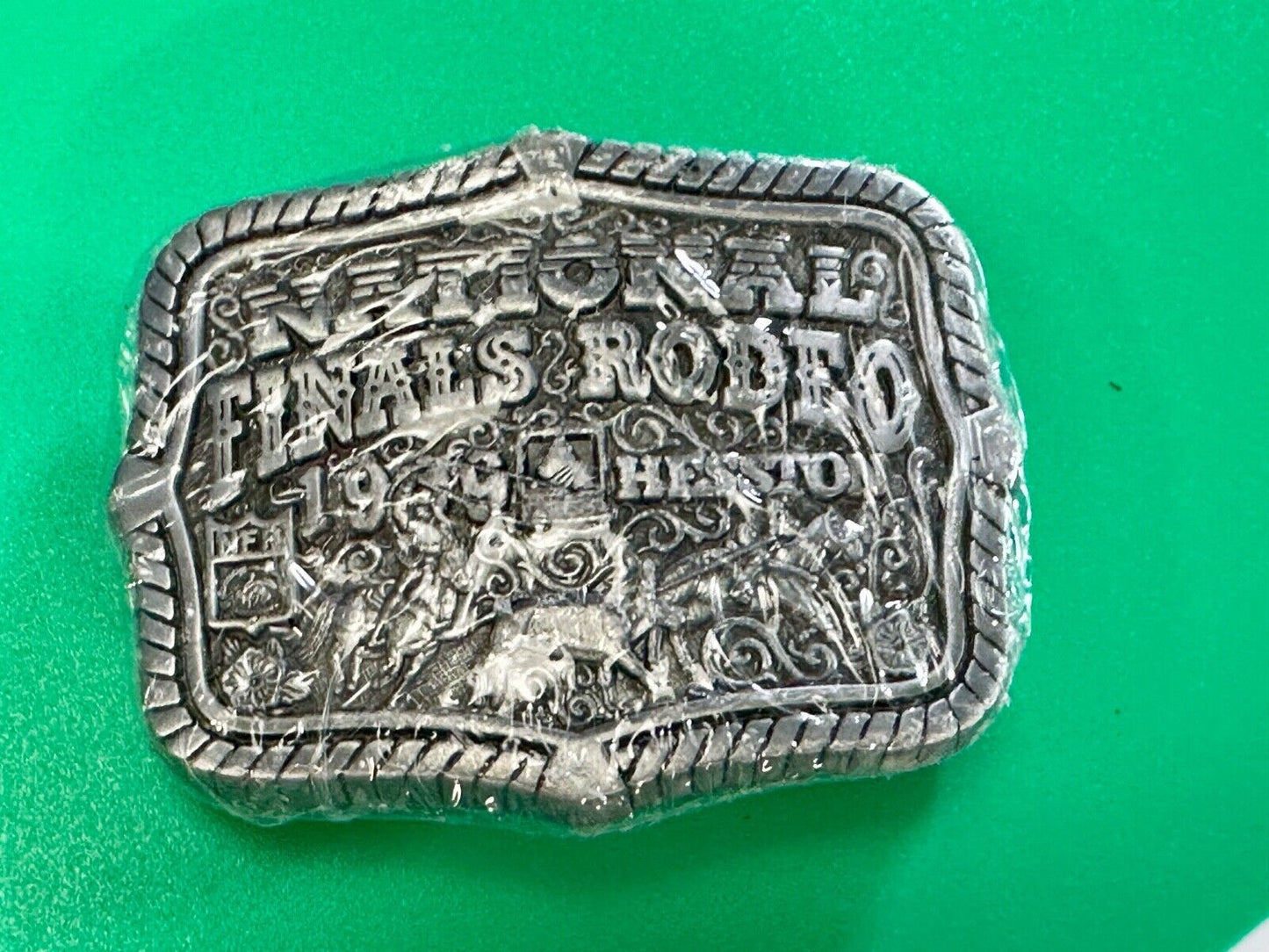 1999 Youth Sized Hesston National Finals Rodeo 2000 series belt buckle in wrap