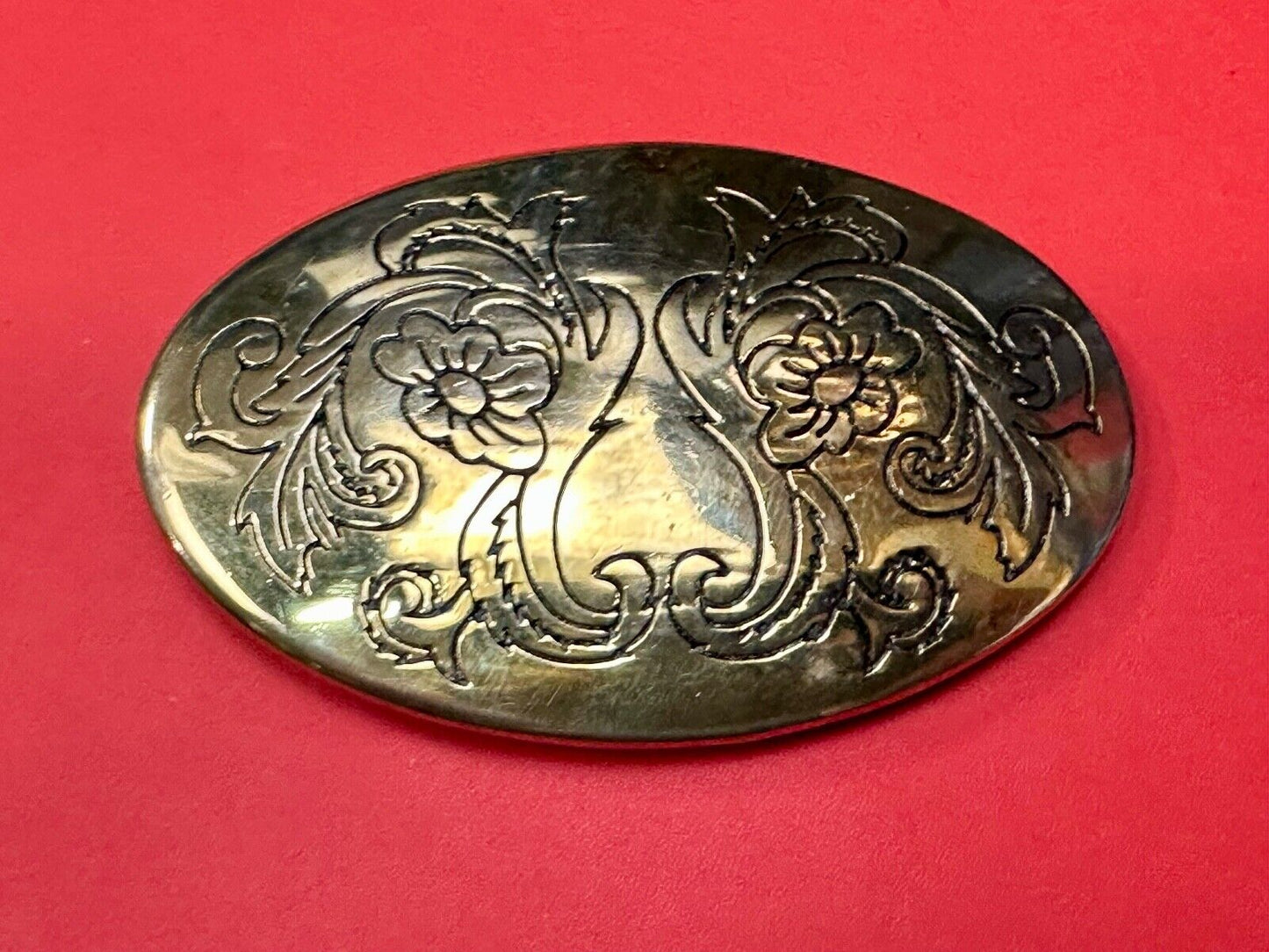 Antique? Engraved flower swirl pattern on gold color oval belt buckle