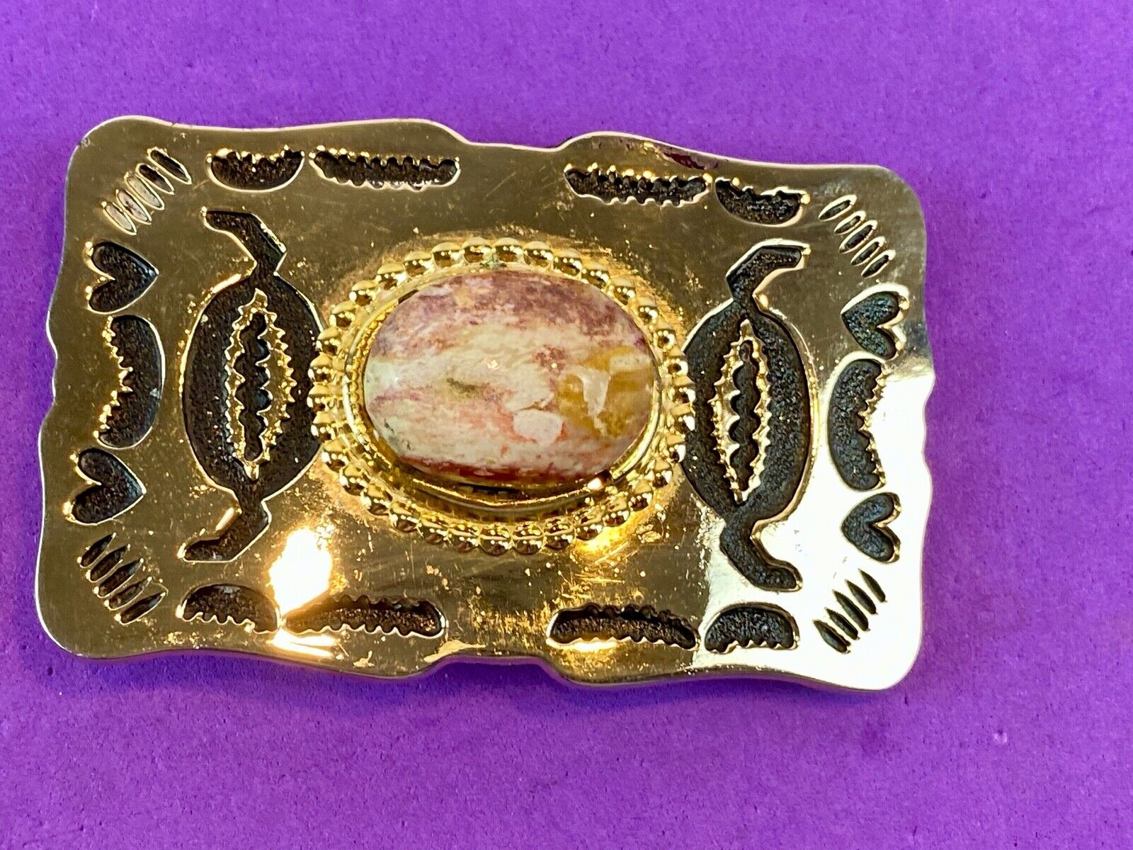 unknown multi layered colored stone as centerpiece in western belt buckle