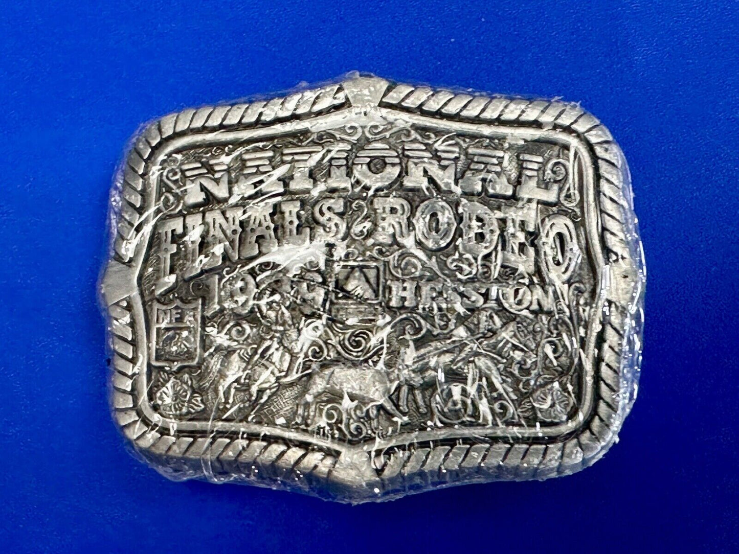 1999 Youth Sized Hesston National Finals Rodeo 2000 series belt buckle in wrap
