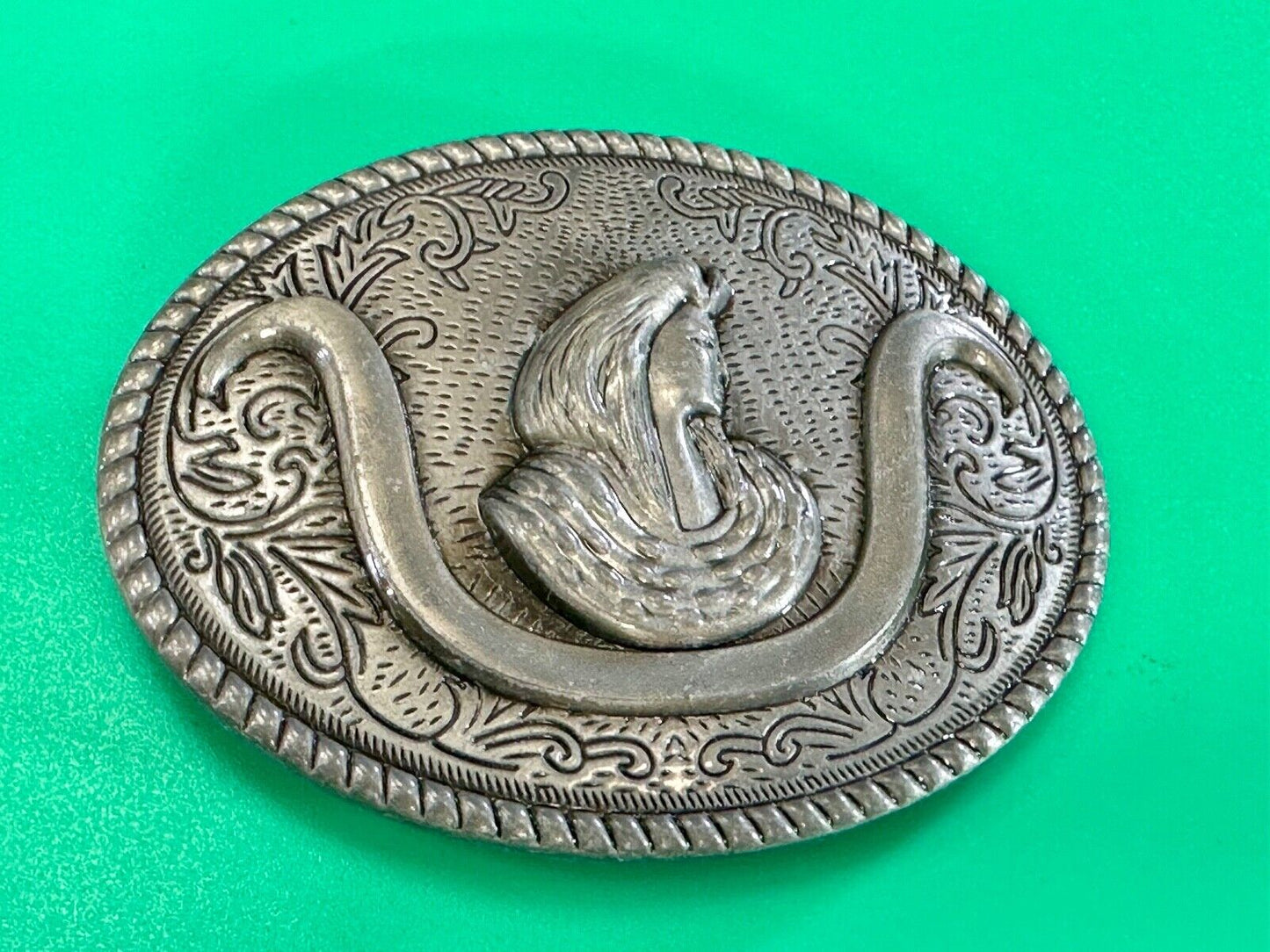 unknown to me!   Man with long hair - longhorn wester belt buckle