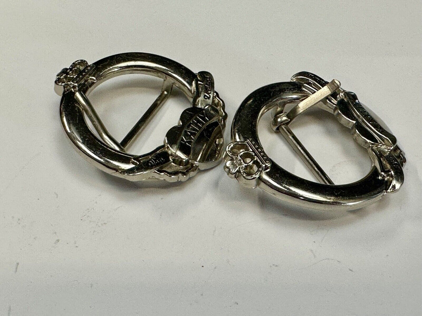 Two Kathy Van Zeeland signed silver tone round heart accented belt buckles