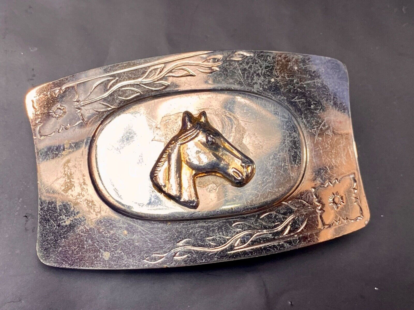 Vintage horse head on western belt buckle