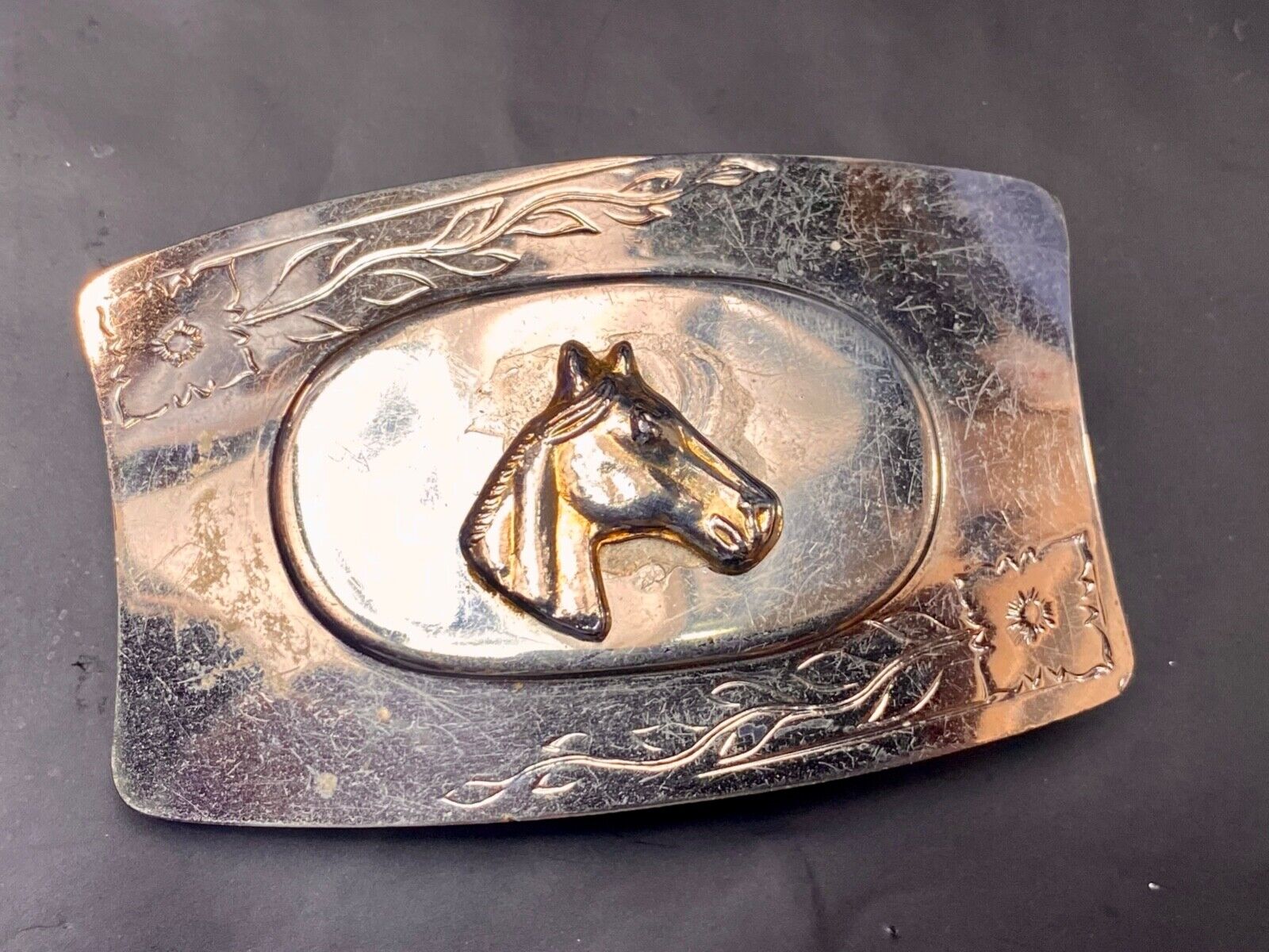Vintage horse head on western belt buckle