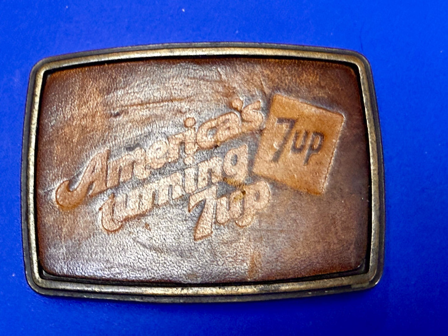 America's Turning 7up Embossed Leather on Metal Advertising Promo Belt Buckle