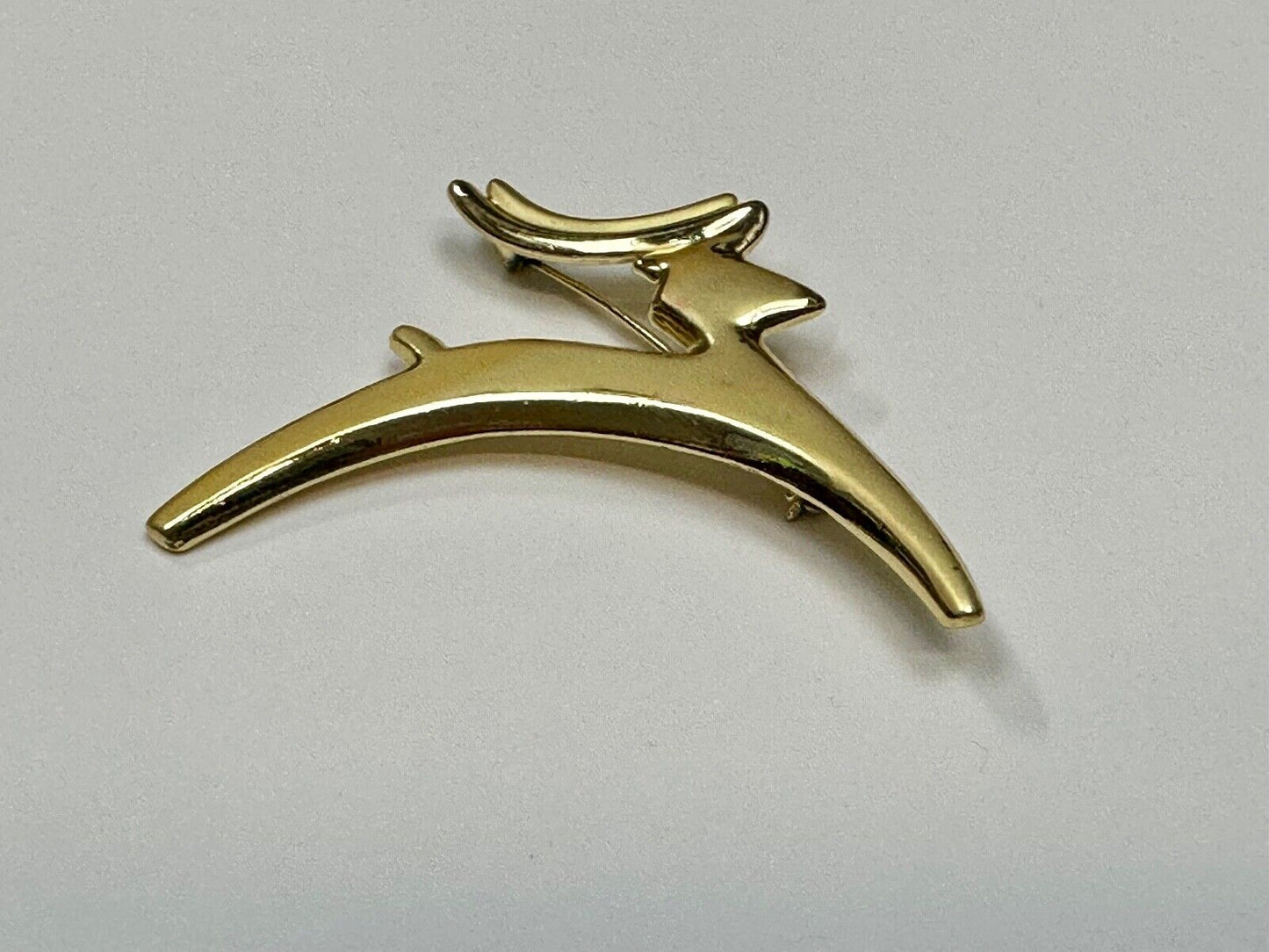 Abstract gold tone running deer - Vintage Christmas Holliday Brooch by AJC