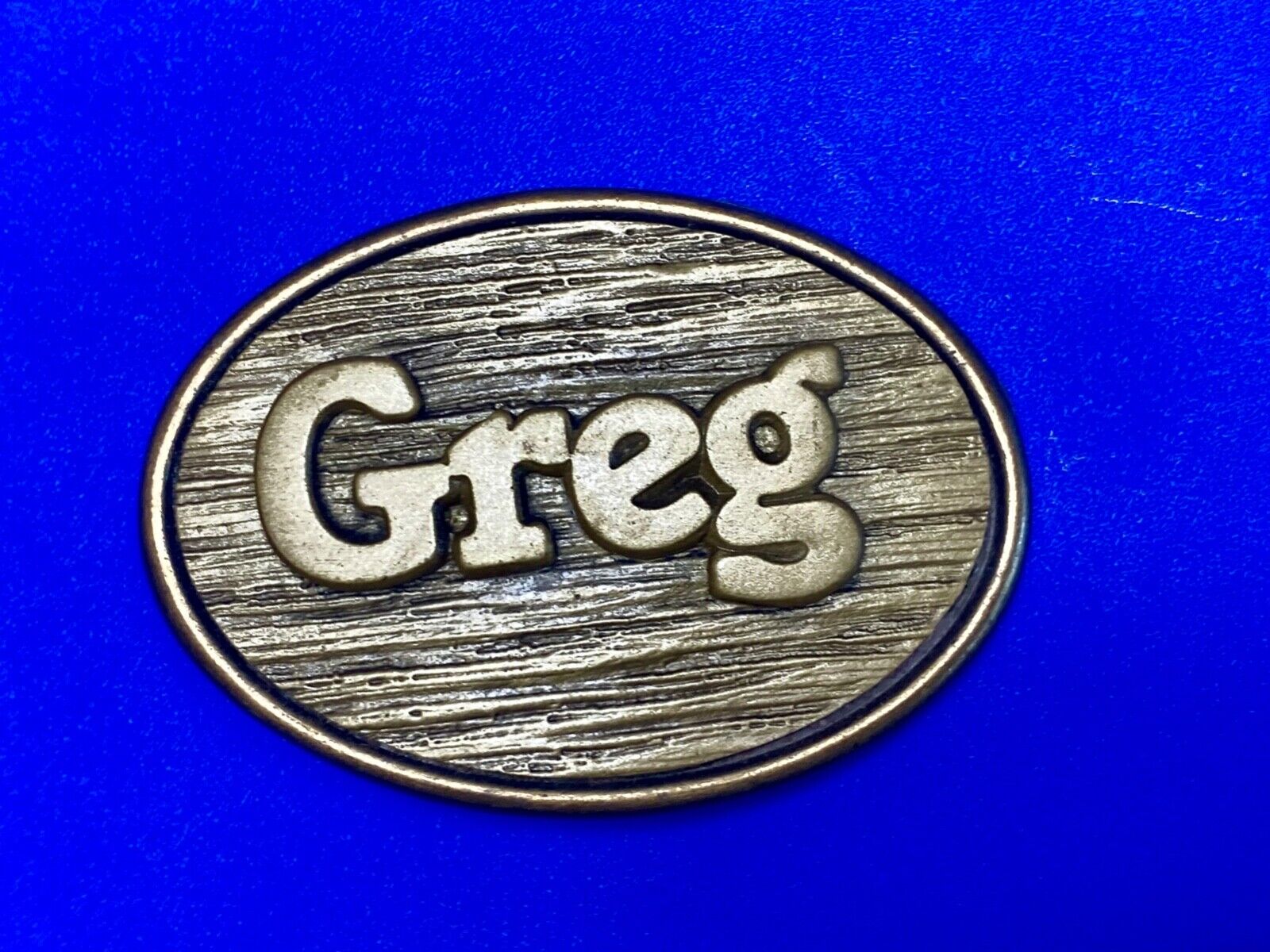 Vintage GREG name metal wood grain western Belt Buckle By Oden - Made In USA