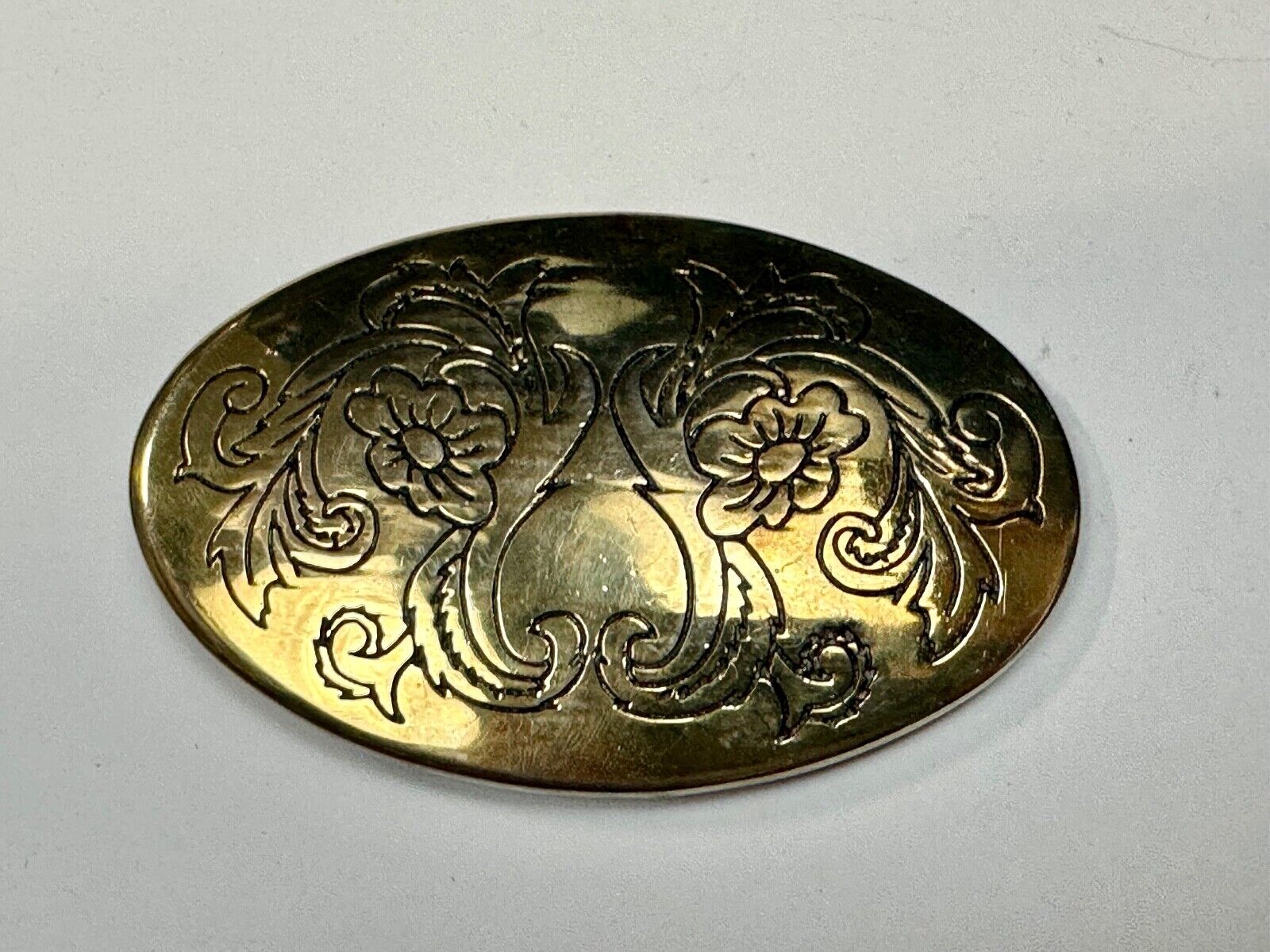 Antique? Engraved flower swirl pattern on gold color oval belt buckle