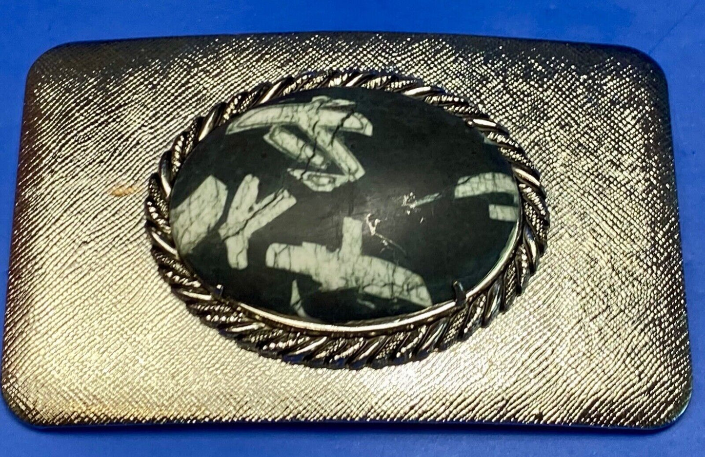 Black & white Oval Cabochon Conch centerpiece on Western belt buckle