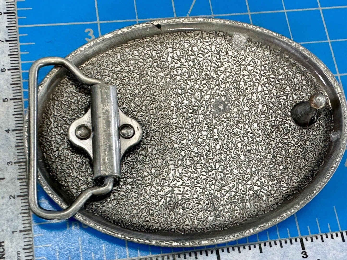 unknown to me!   Man with long hair - longhorn wester belt buckle
