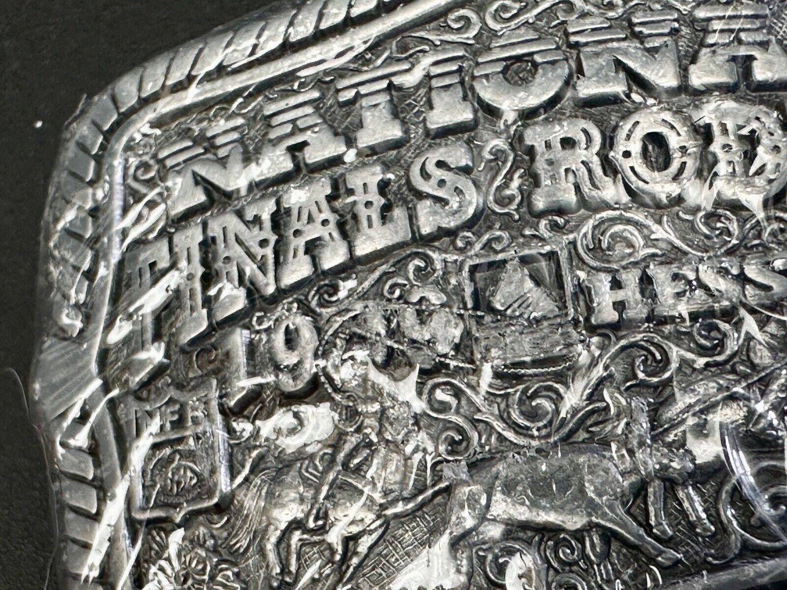 1999 Youth Sized Hesston National Finals Rodeo 2000 series belt buckle in wrap