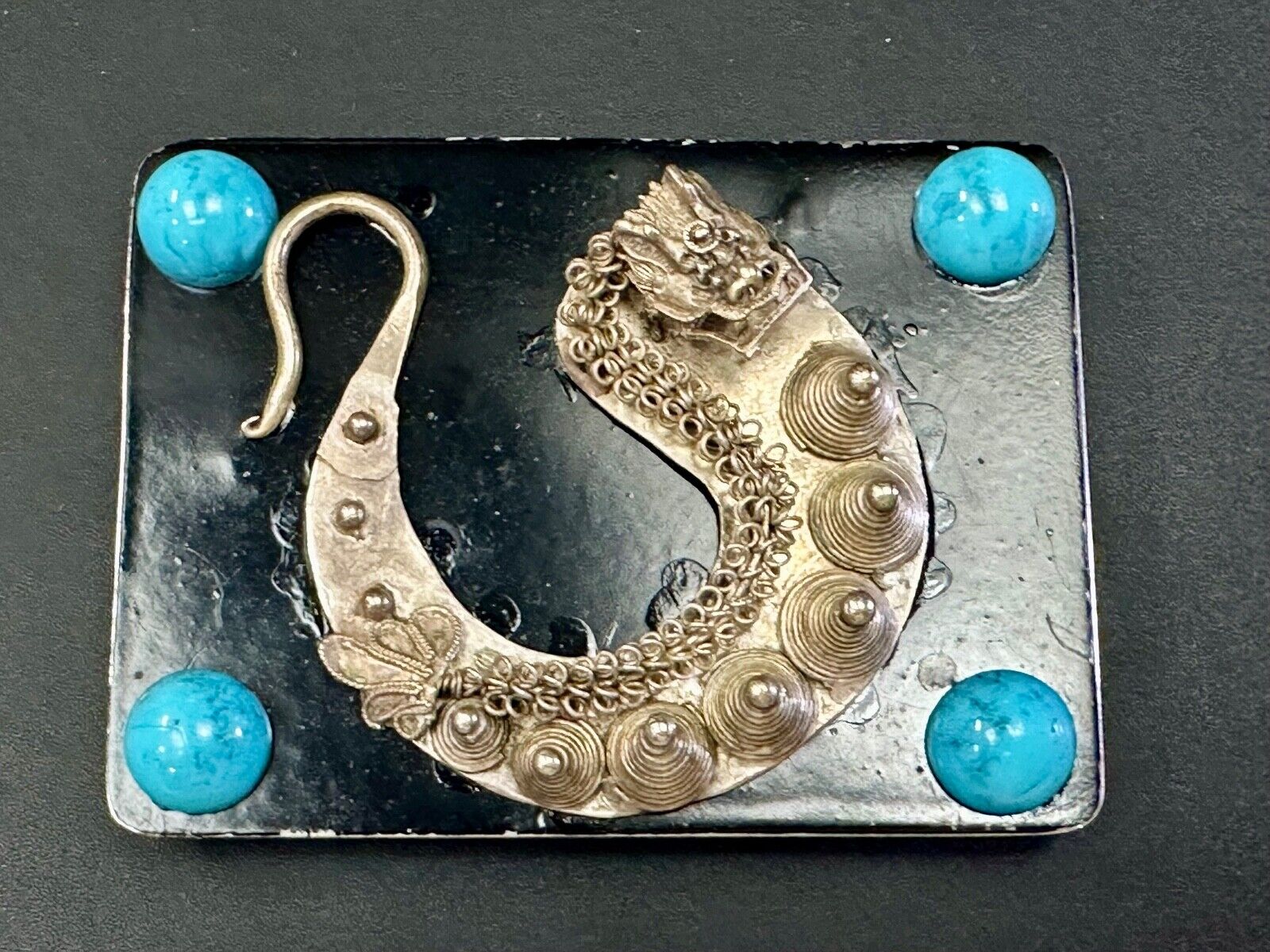 Artisan Dragon theme rectangular belt buckle with turquoise colored corner accts