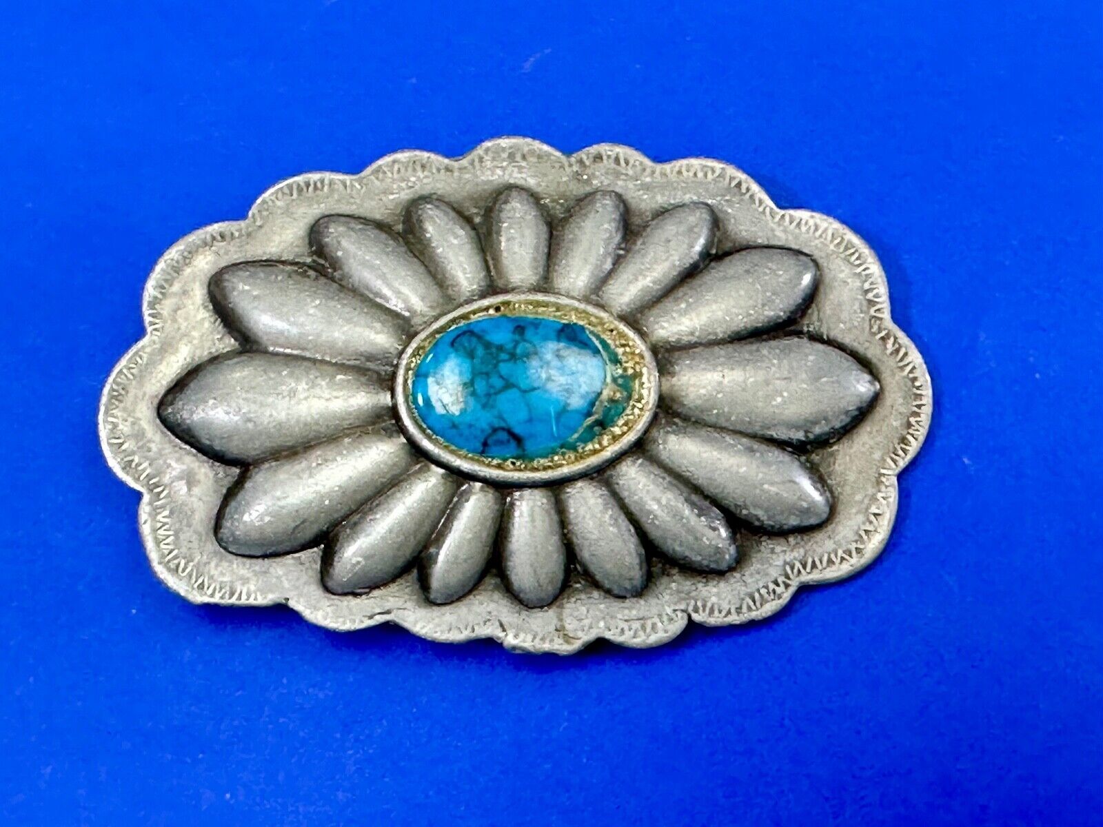 Turquoise stone centered on Vintage metal flower theme belt buckle