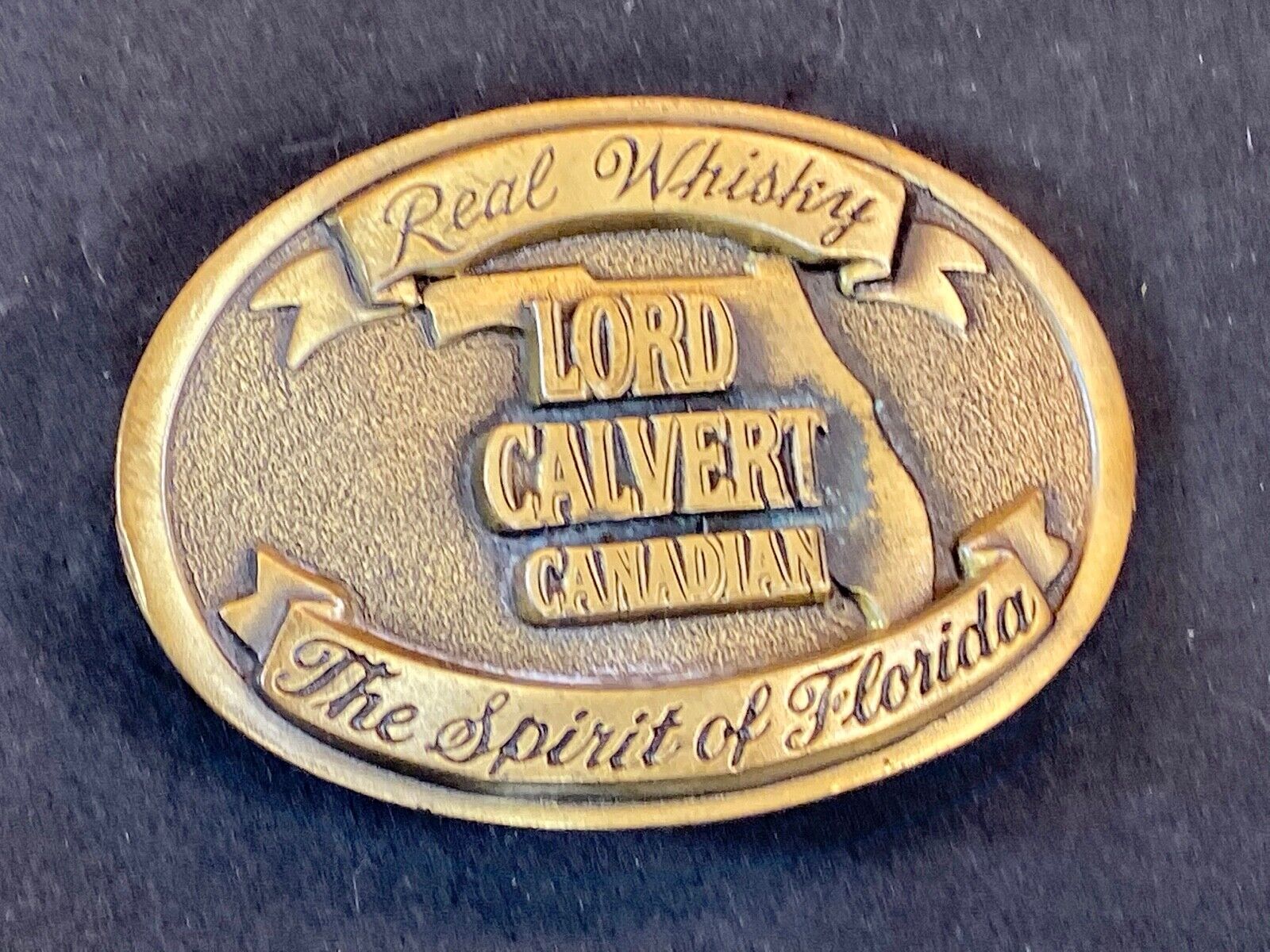 Vintage Lord Calvert Canadian Real Whisky.  Spirit Of Florida Belt Buckle 