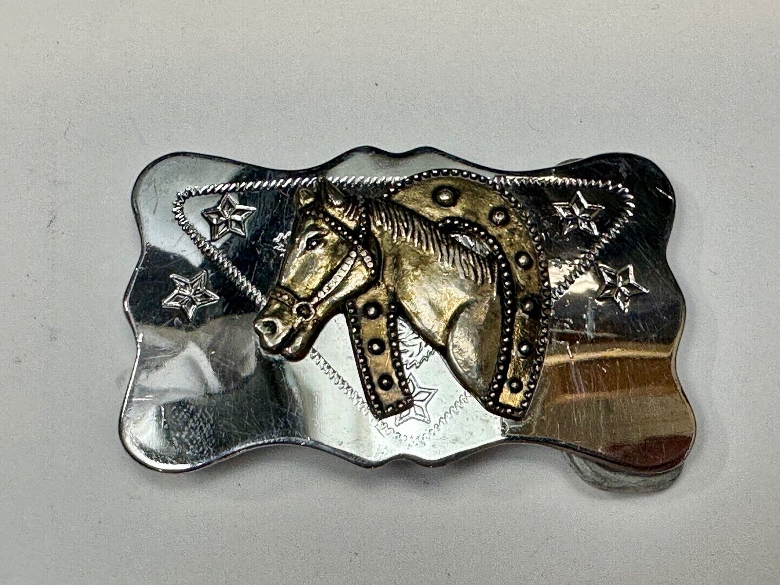 Vintage Horse head through horseshoe on reflective two tone belt buckle