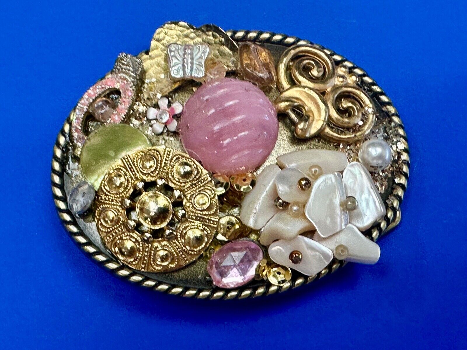Artisan Abstract flowers made of mixed material on gold tone oval belt buckle